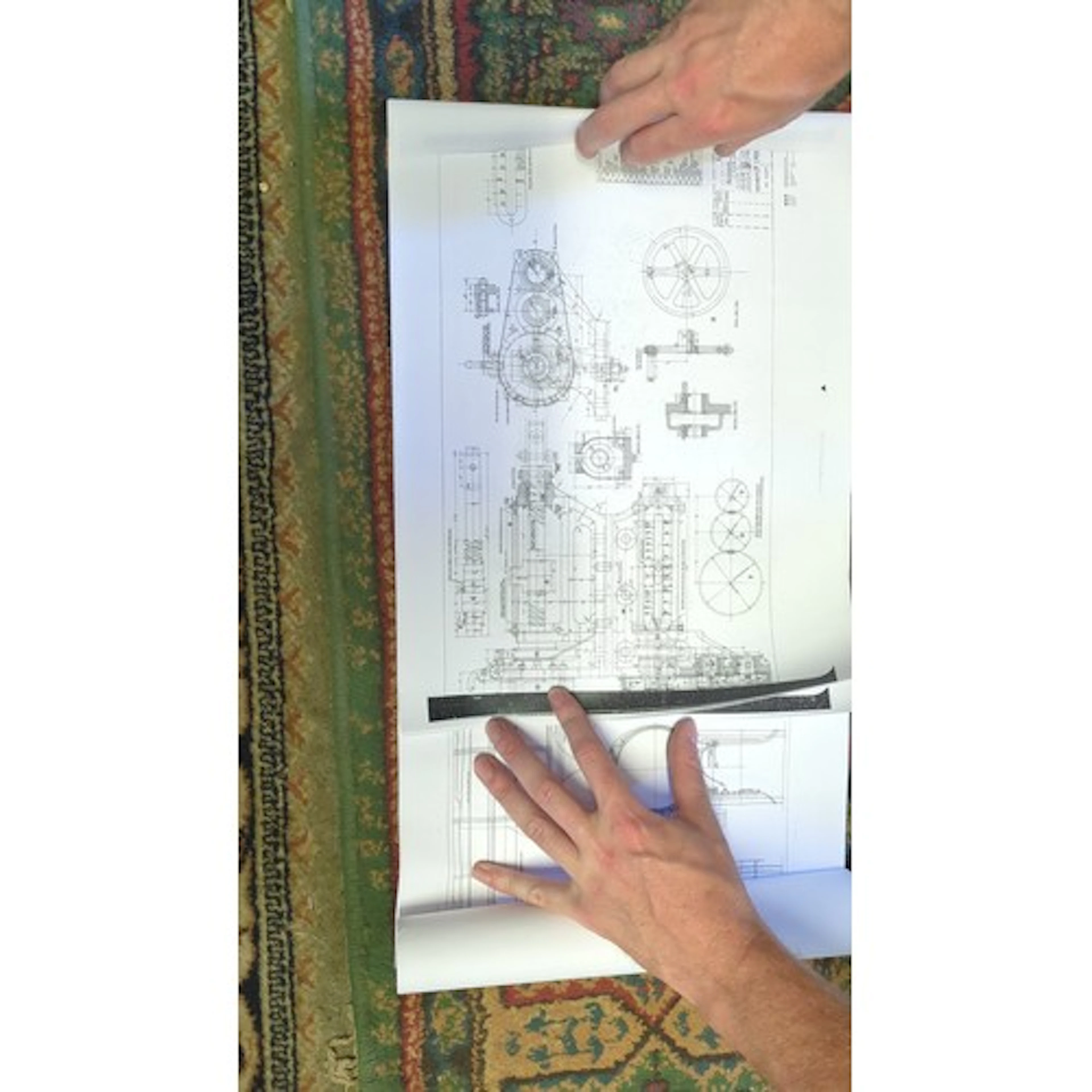 A group of engineering blueprints and technical drawings, in...