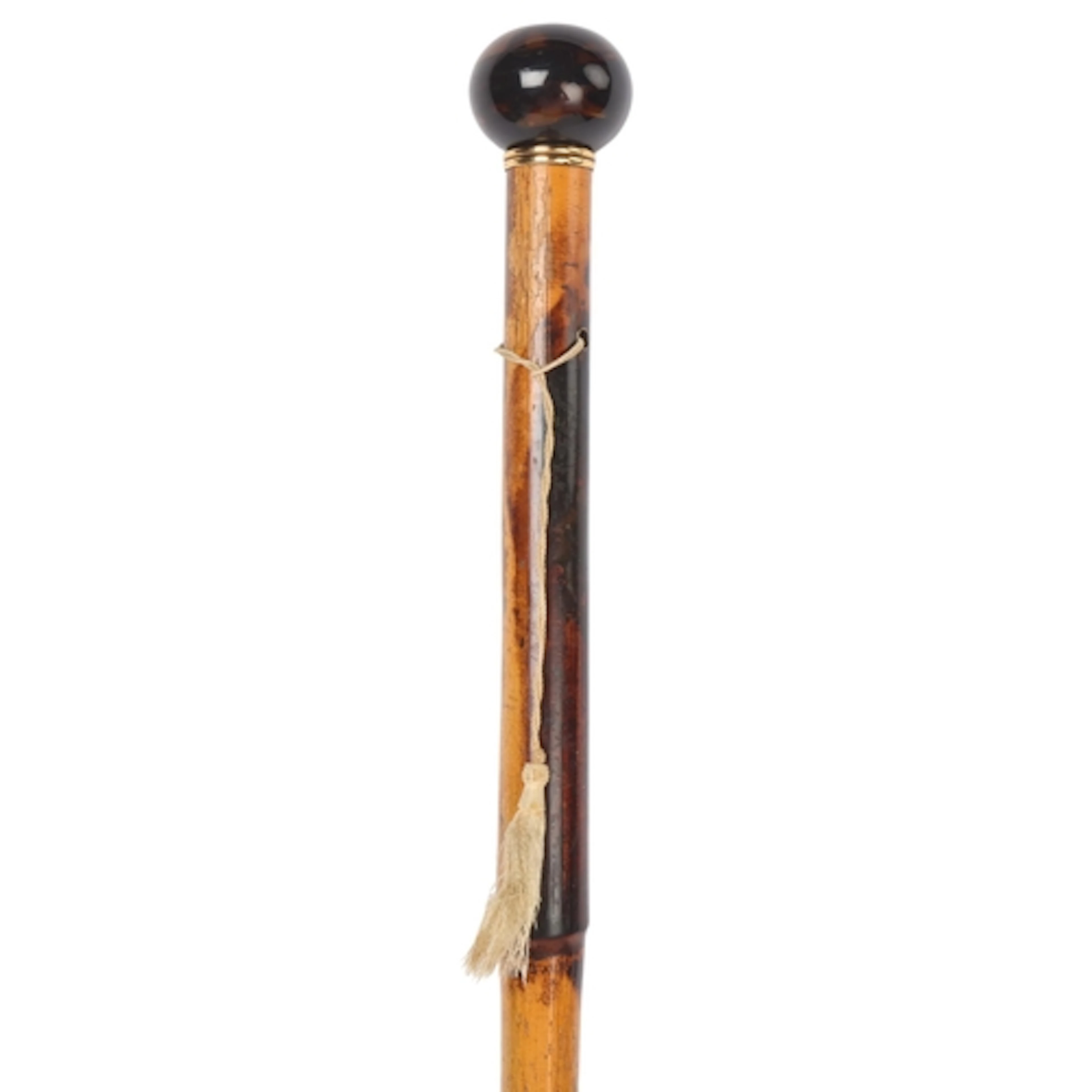 An antique tortoiseshell-handled cane, the spherical handle ...
