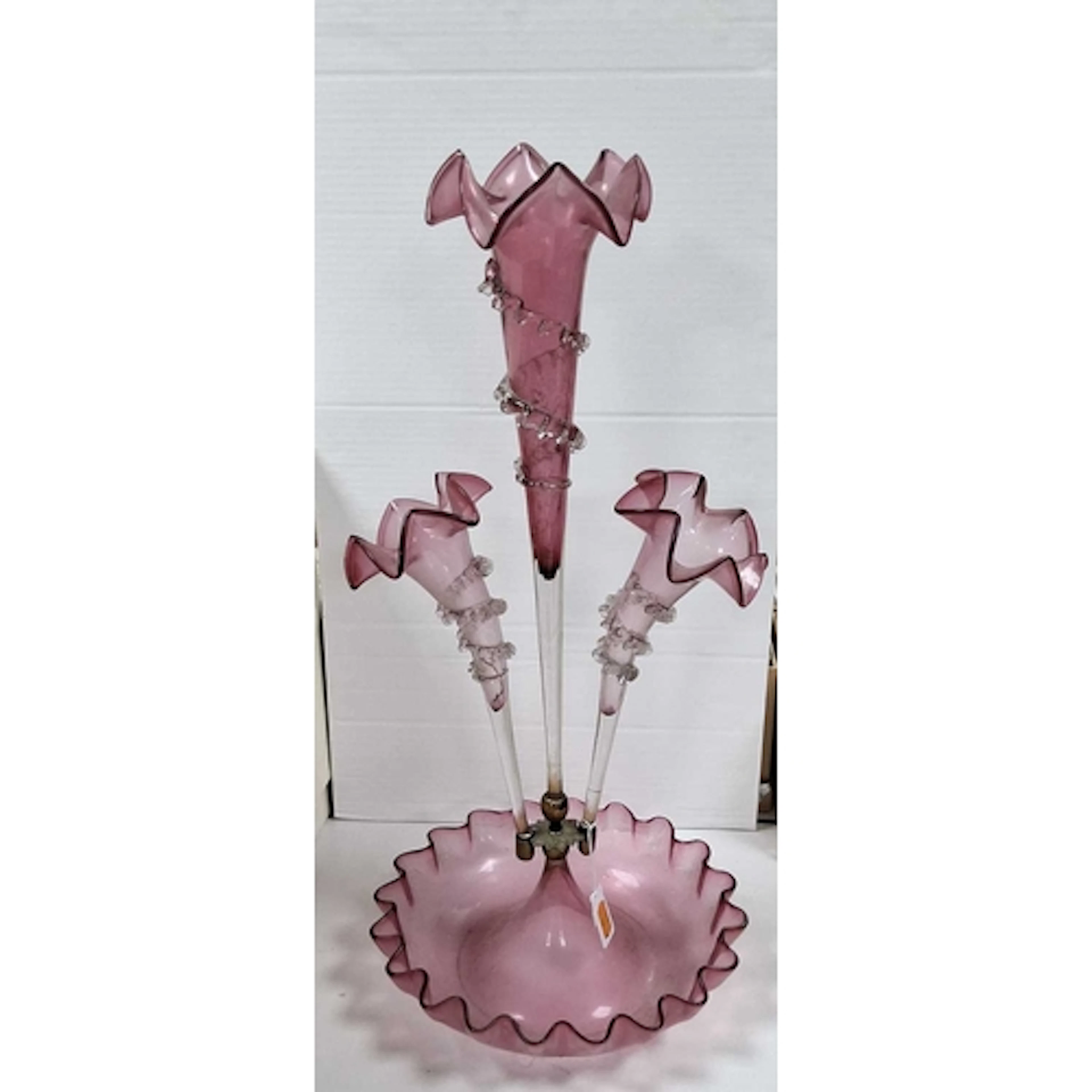 A CRANBERRY GLASS EPERGNE, featuring a central trumpet and t...