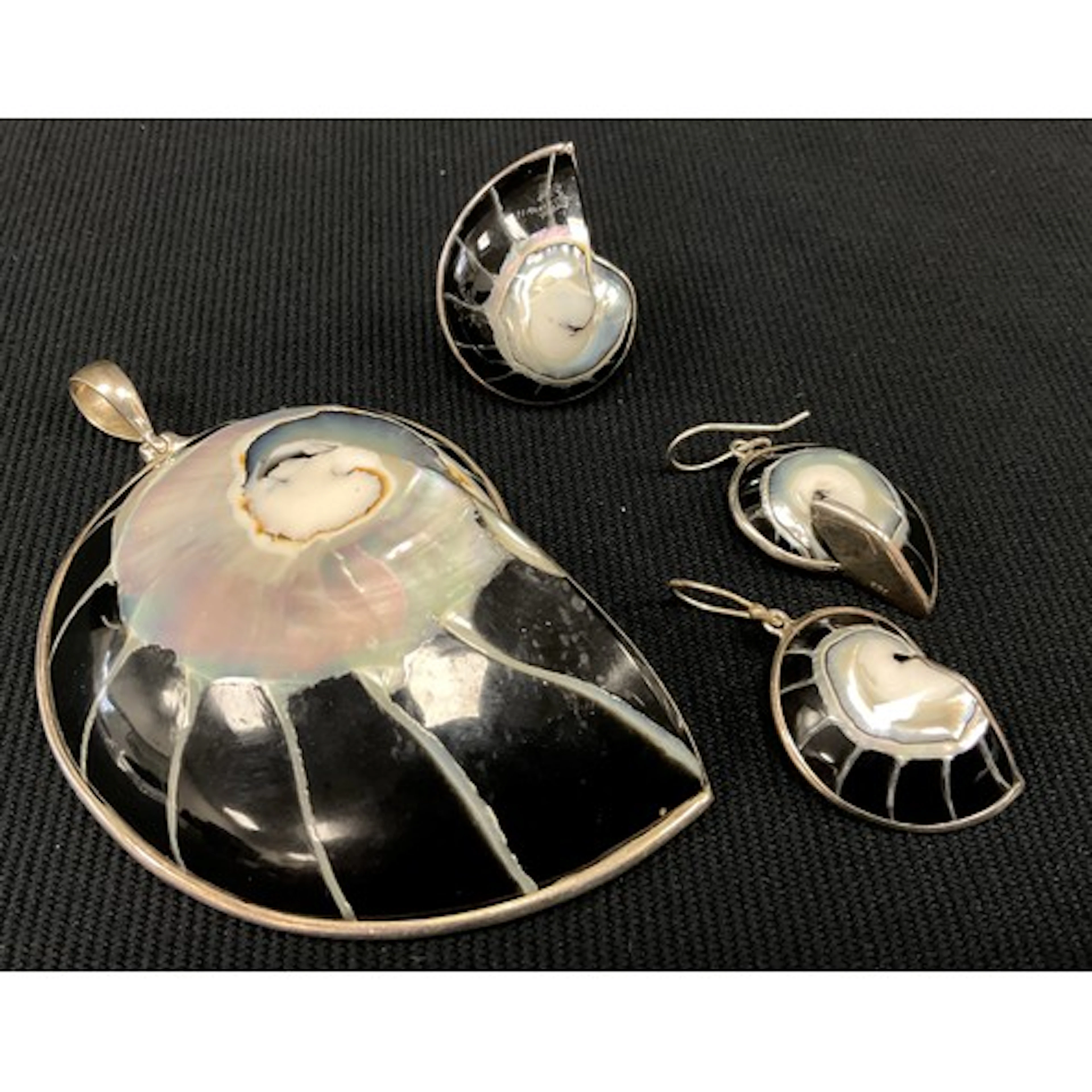 A silver mounted nautilus shell pendant, similar ring and ea...