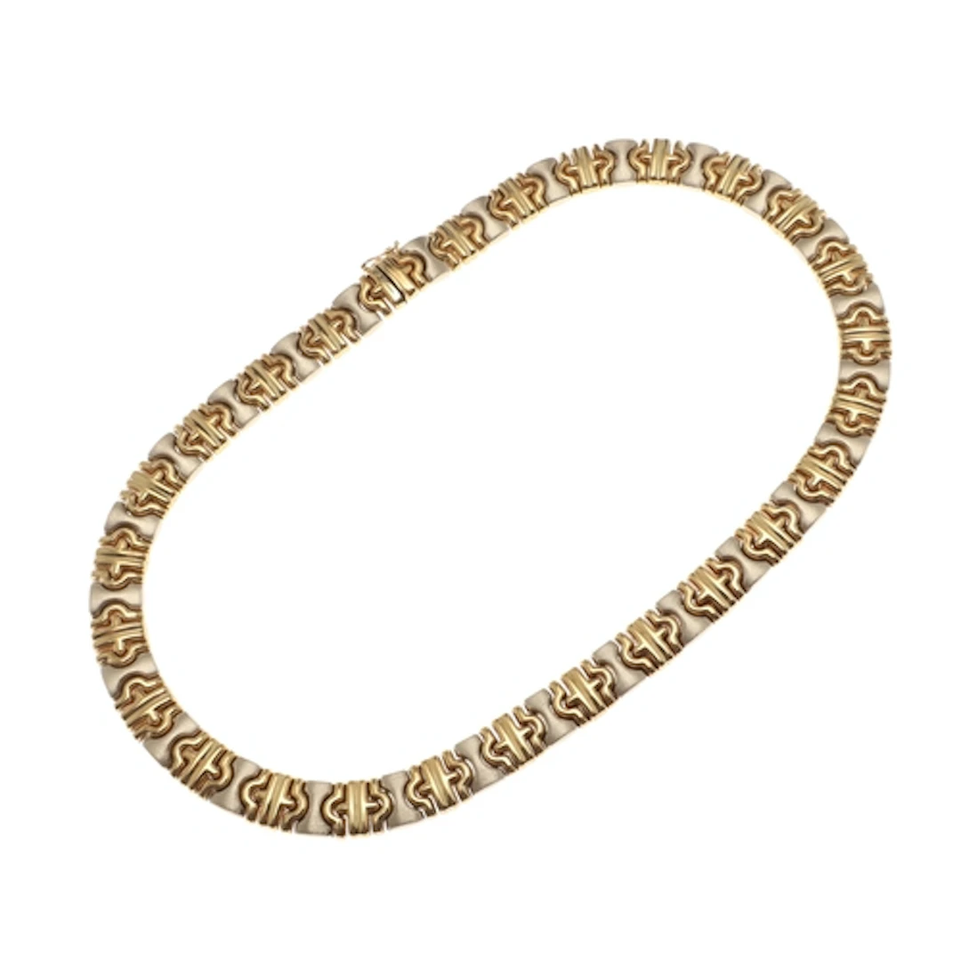 AN 18CT TWO COLOUR GOLD NECKLACE. of geometric design, forme...