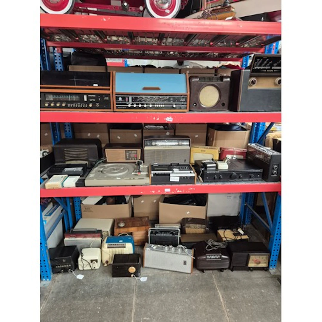 Three shelves of vintage radios and other electricals. Dynat...