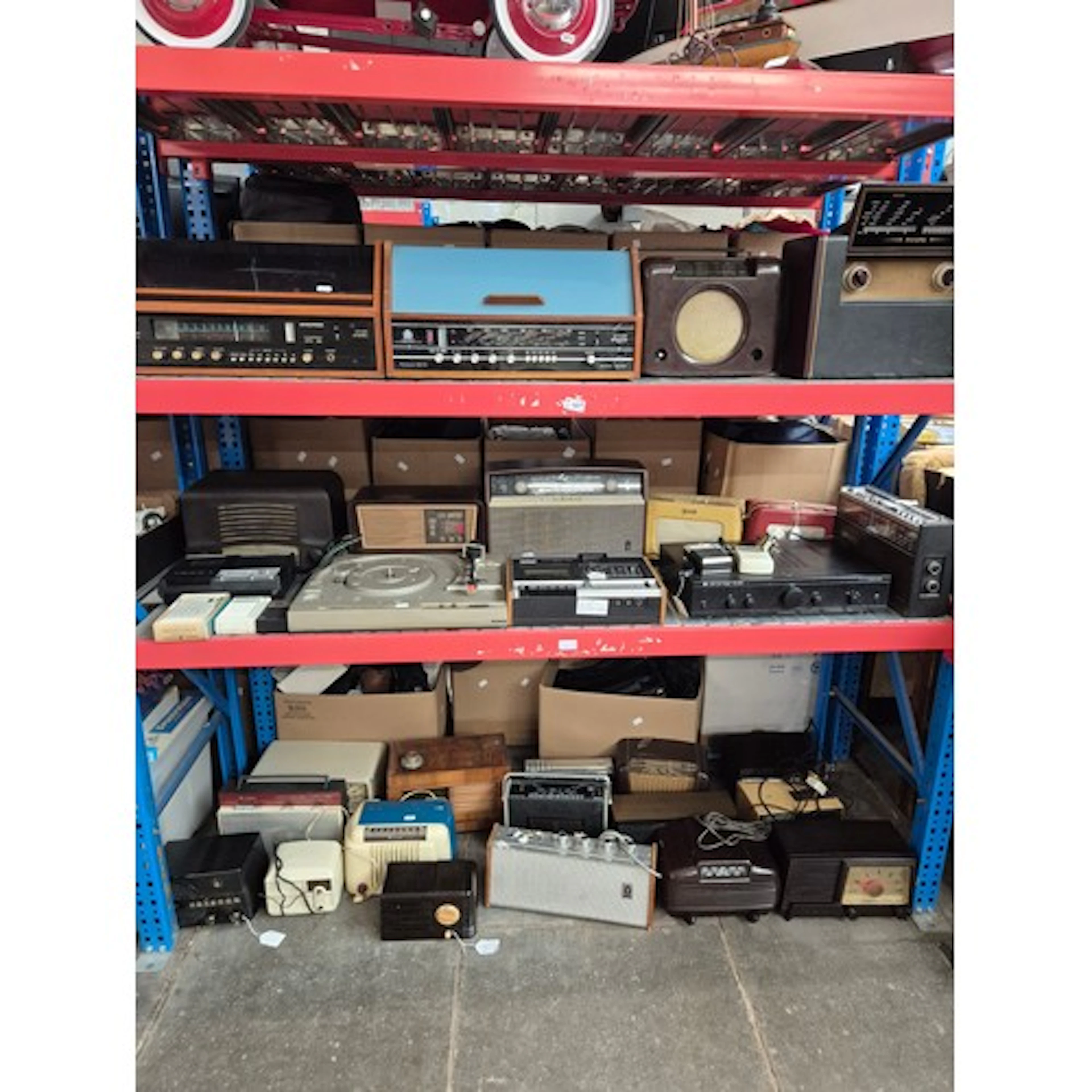 Three shelves of vintage radios and other electricals. Dynat...