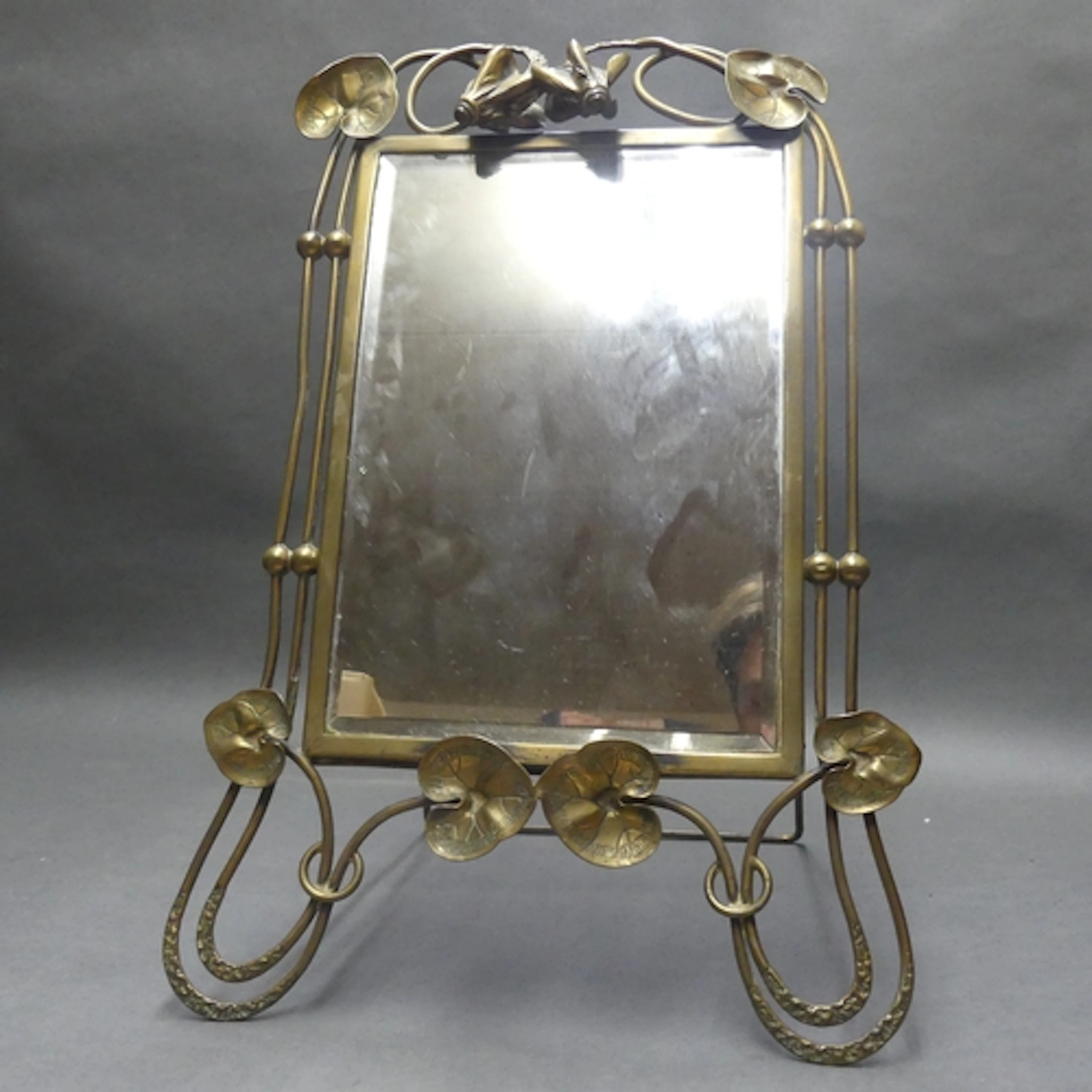 An impressively formed Art Nouveau brass framed bevel edge v...
