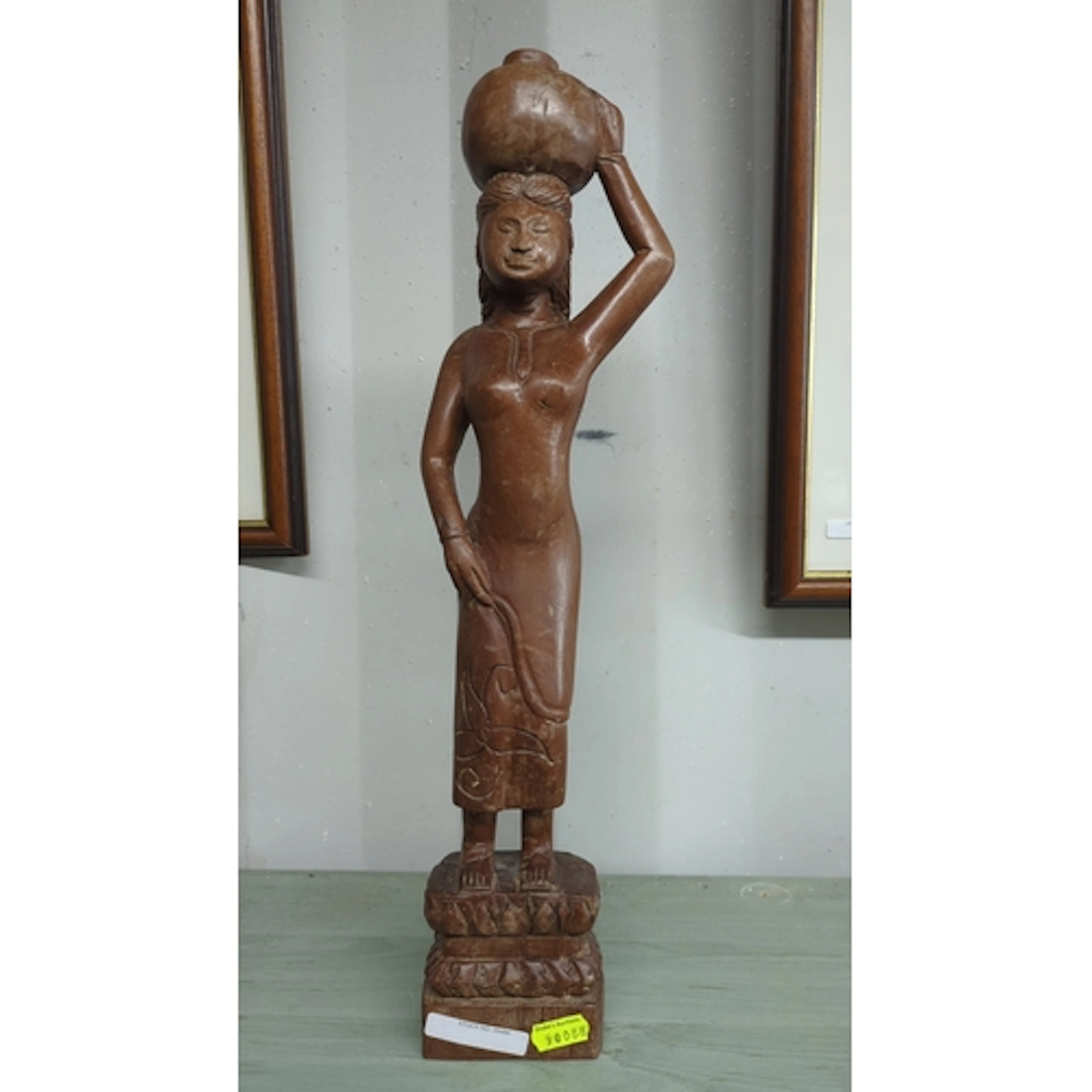 African carved hardwood figure of a woman balancing a vessel...