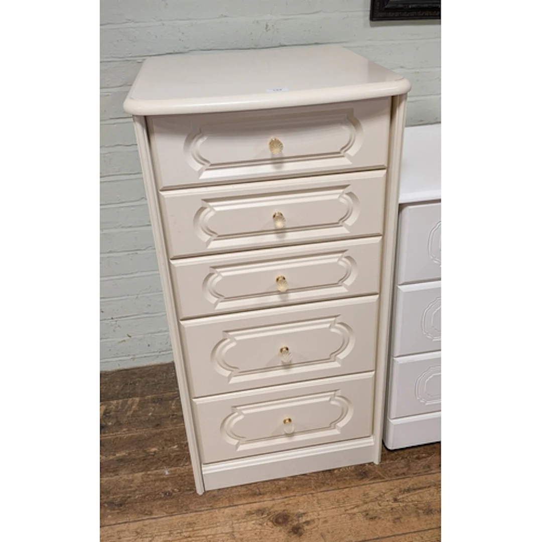 A matching cream tallboy chest of five long drawers with bra...
