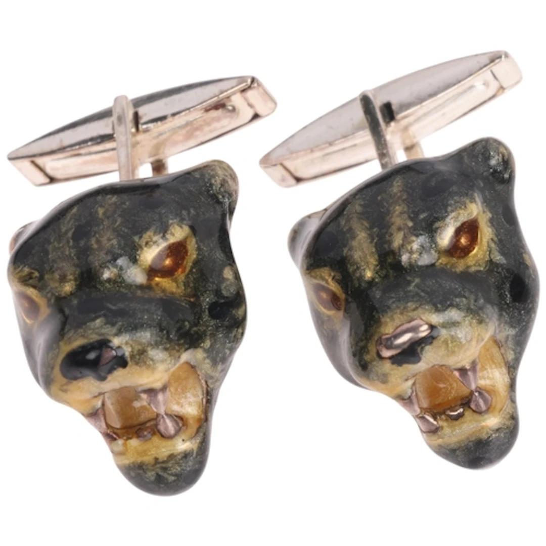 A pair of sterling silver and enamel panther-head cufflinks,...