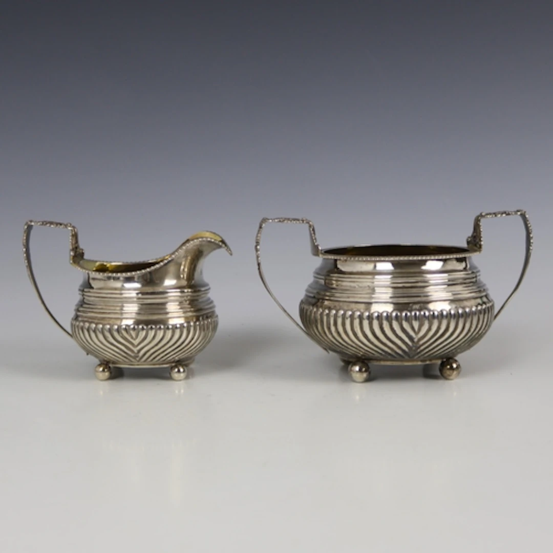 A George IV silver sugar bowl and milk jug, J E Terrey & Co,...