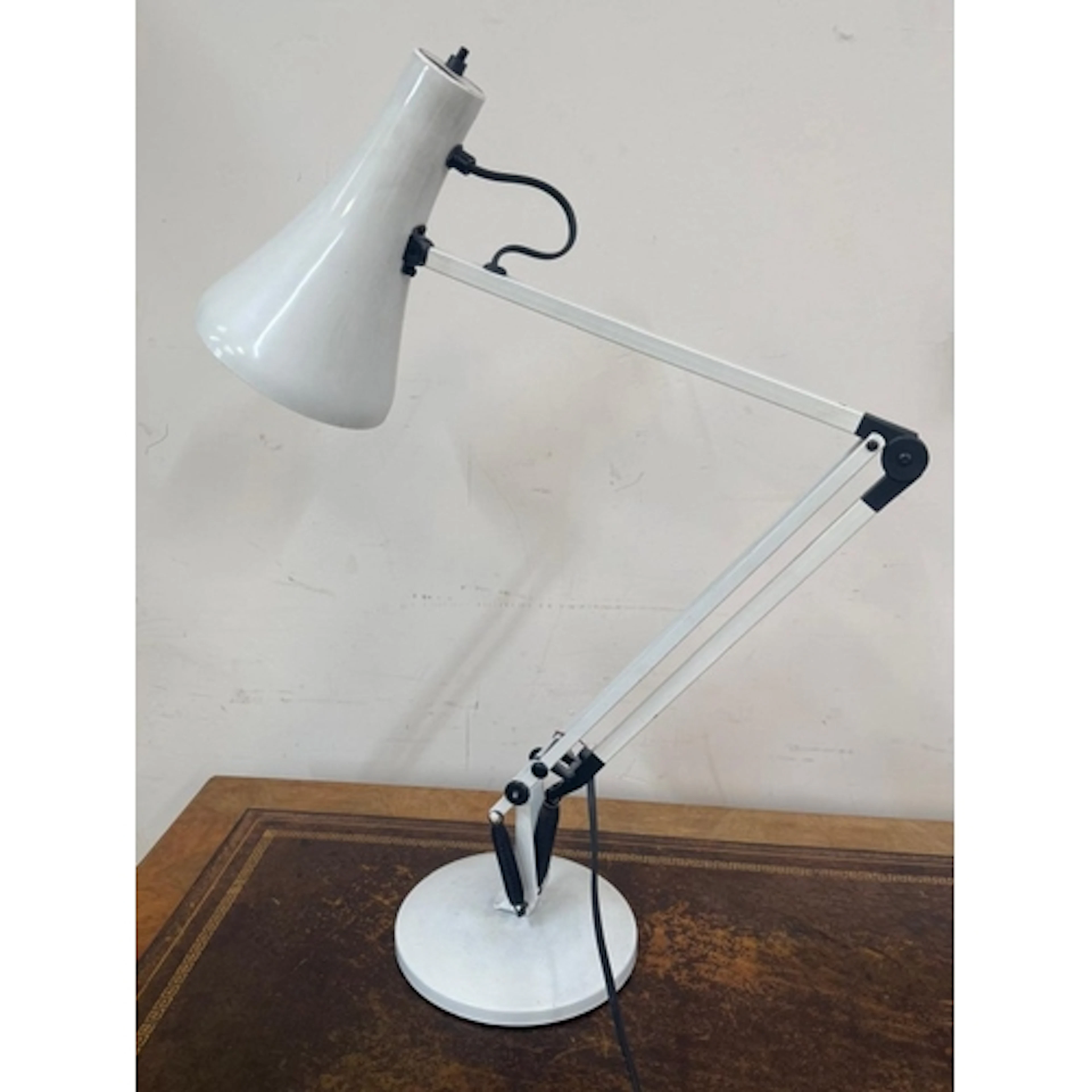 A white anglepoise desktop lamp