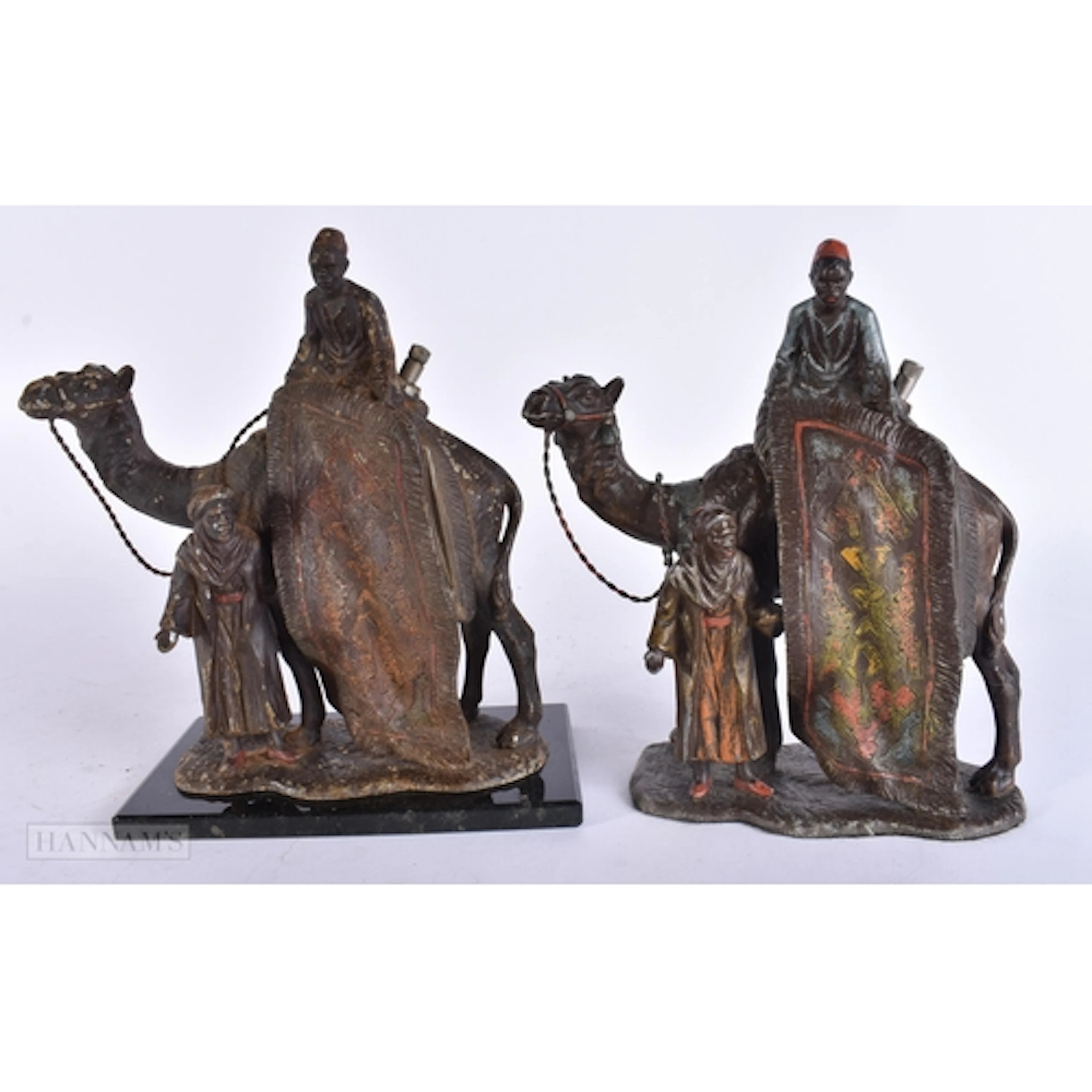 A PAIR OF ART DECO COLD PAINTED SPELTER ARABIC CAMEL LIGHTER...