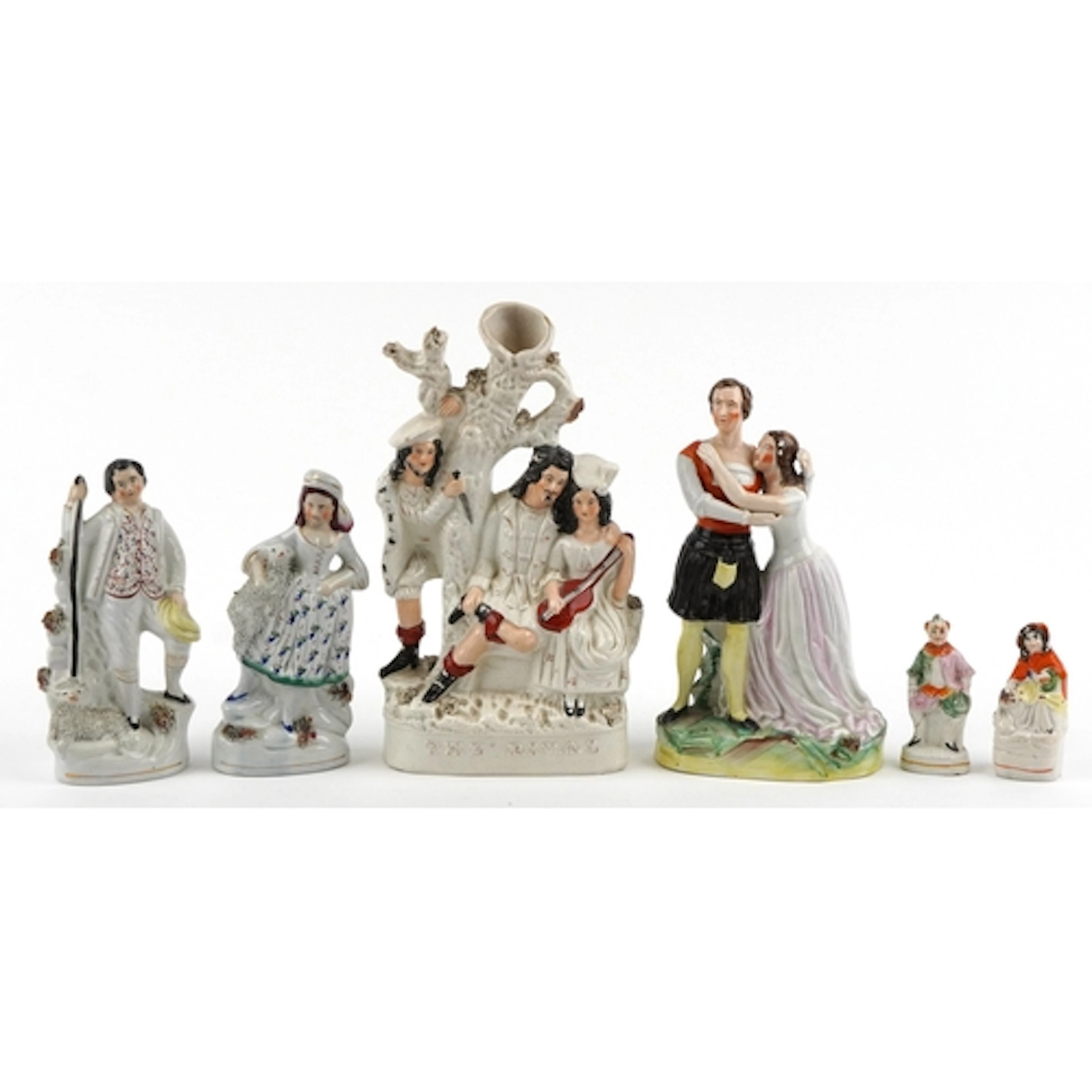 Six Victorian Staffordshire pottery figures including a flat...