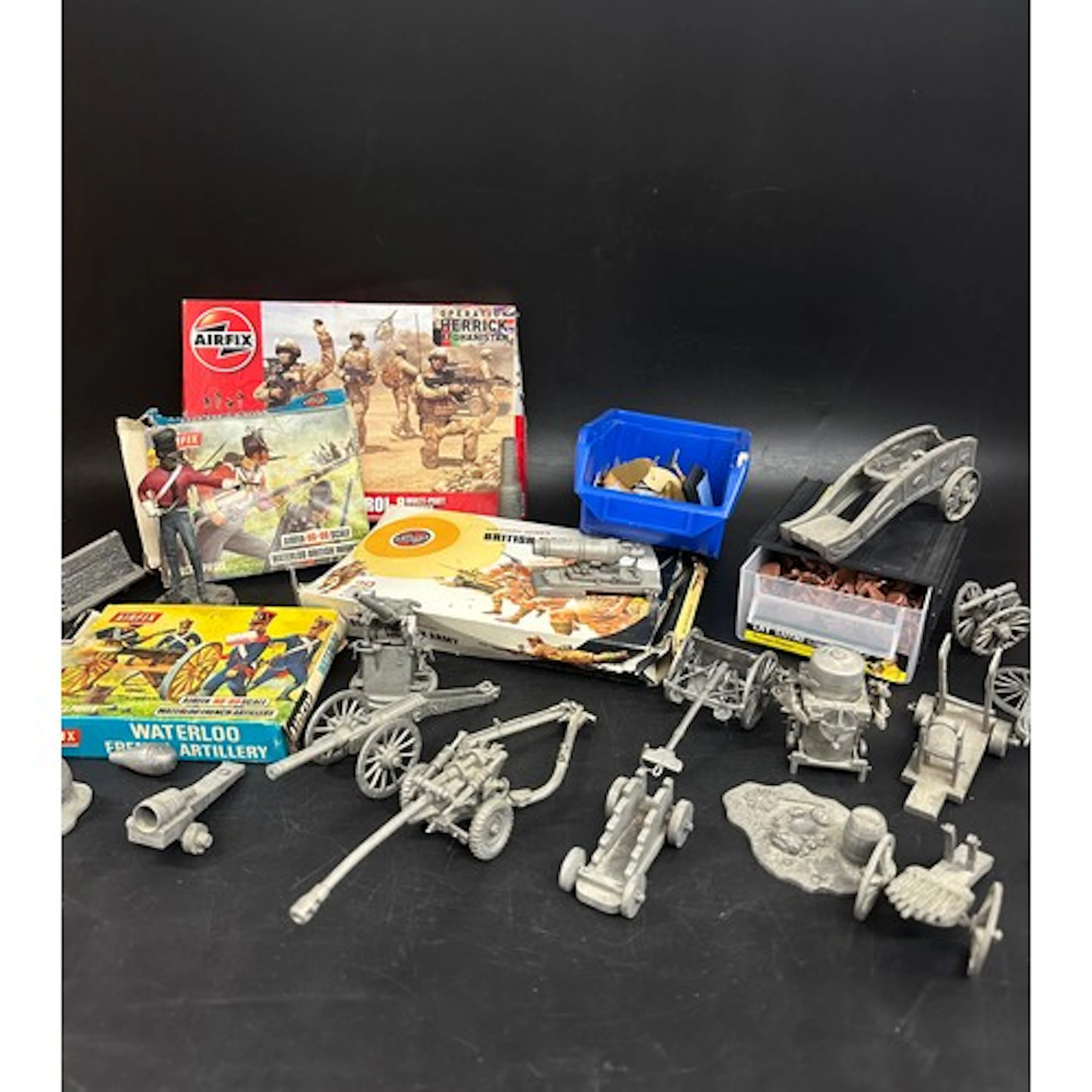 A collection of Airfix toy soldiers and metal model cannons,...