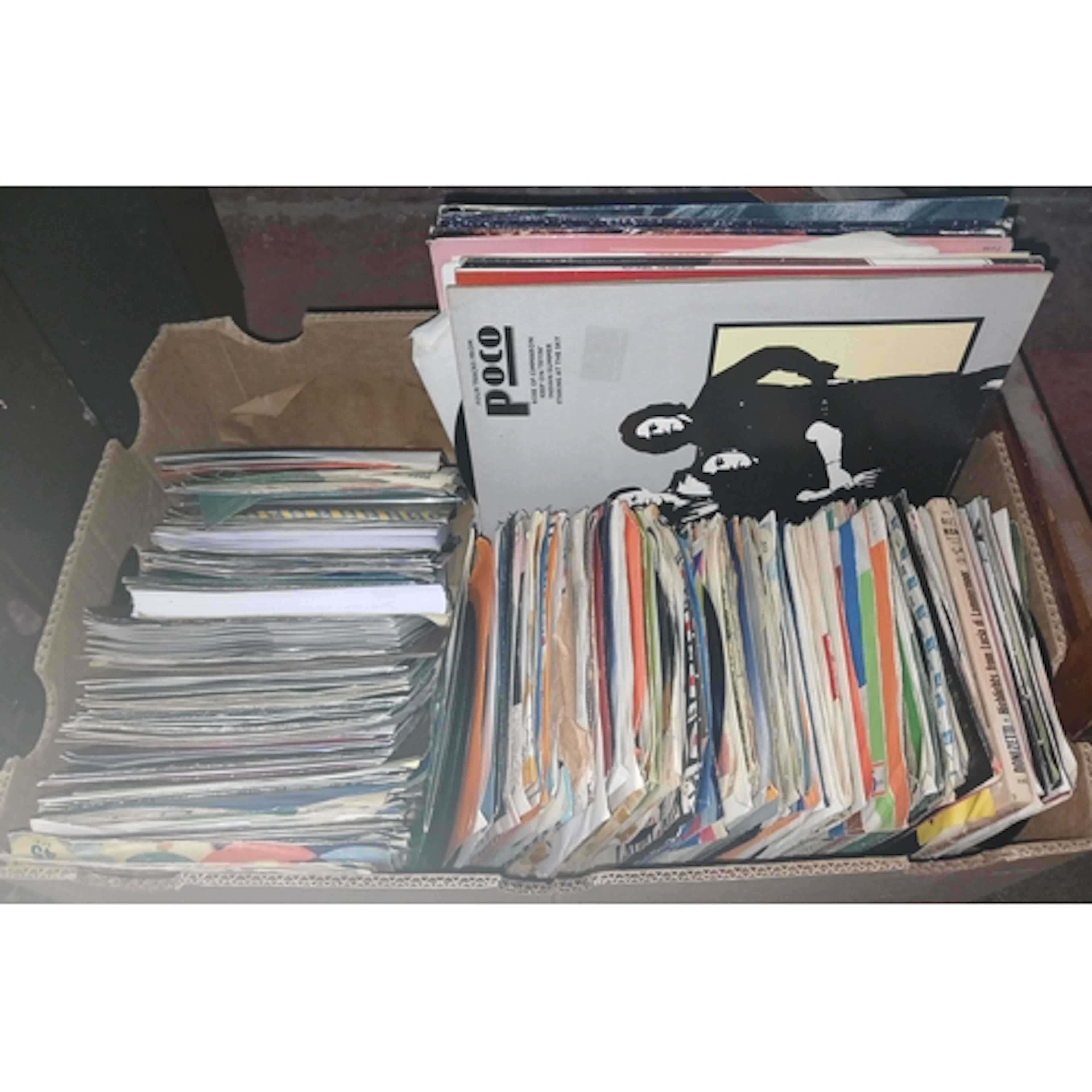 A box of assorted 7" and 12" singles.