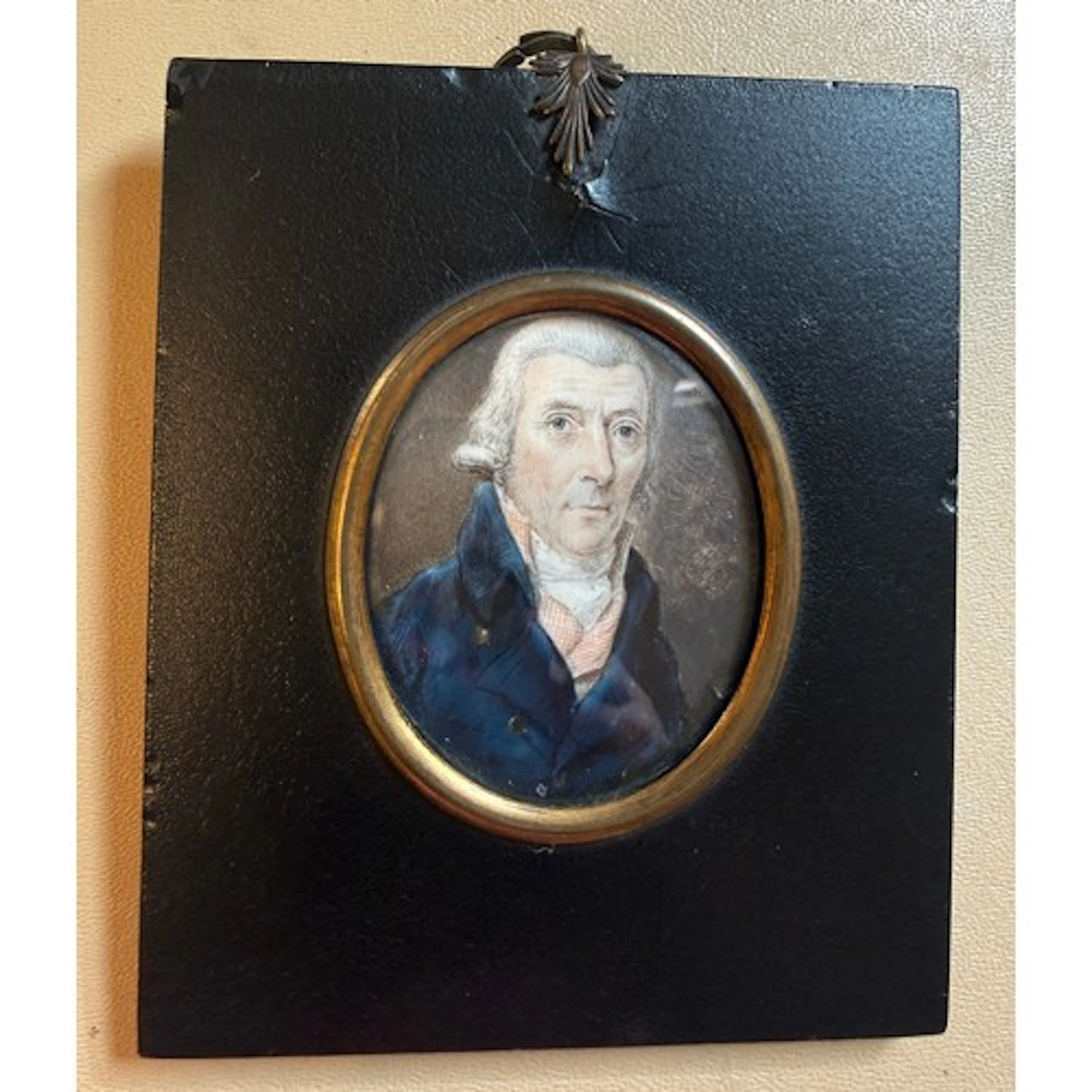 A painted miniature portrait on ivory of a gentleman in a bl...