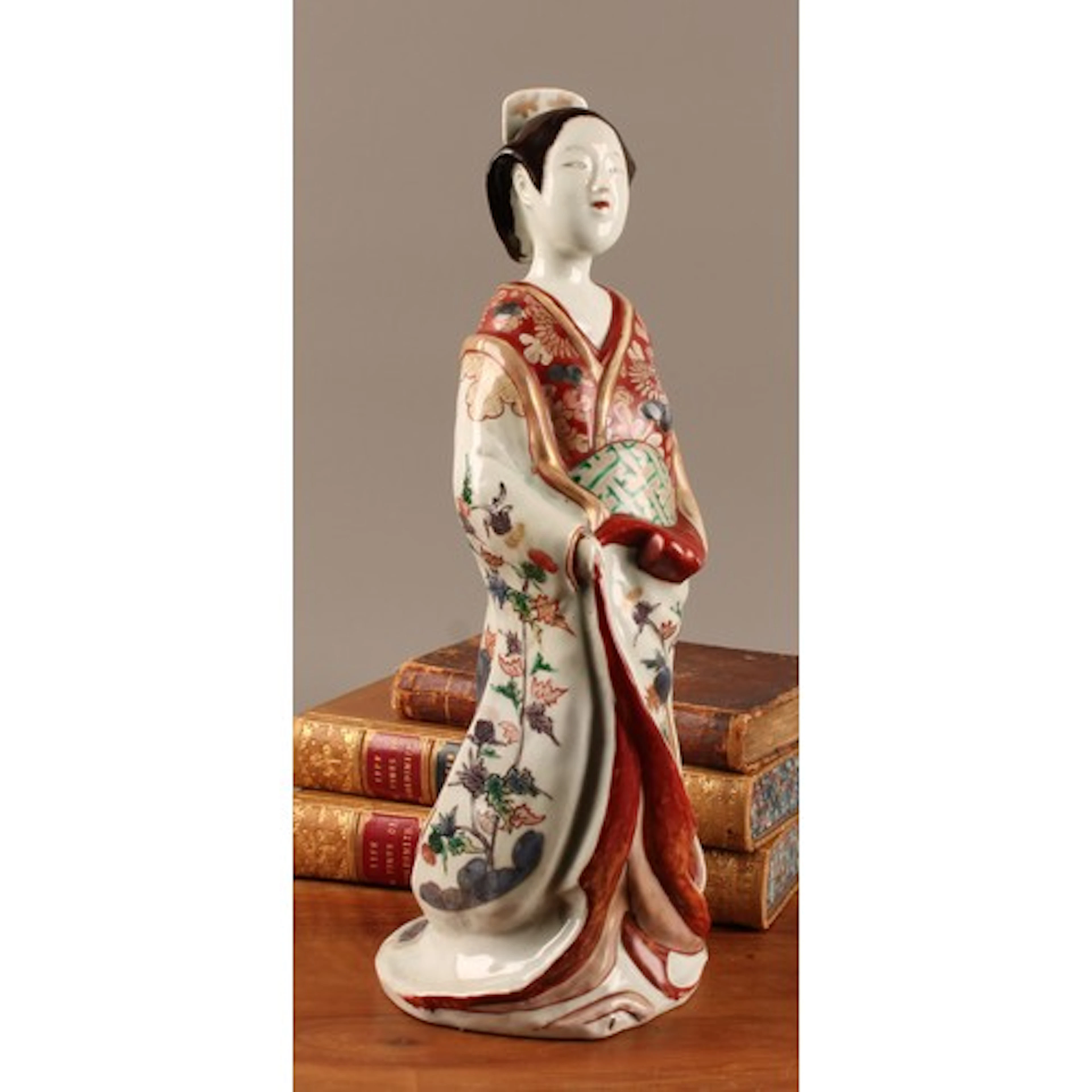 A Japanese kakiemon porcelain figure, of a bijin, decorated ...