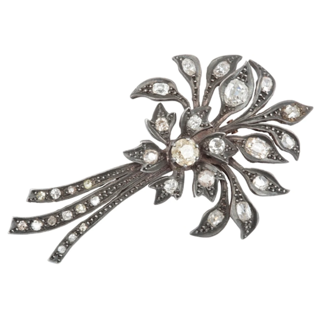 A diamond brooch, designed as a spray of flowers, set with c...