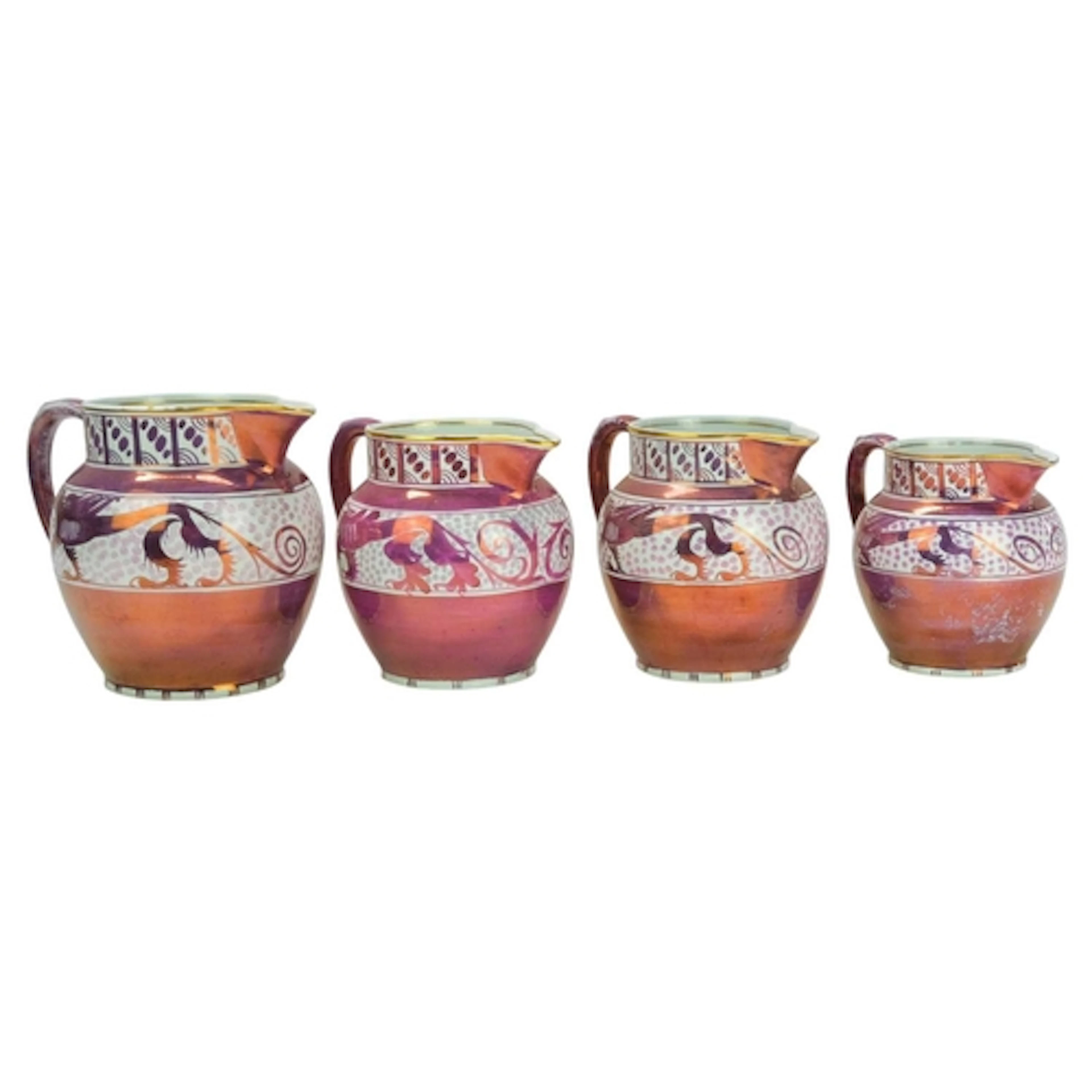 A graduated set of three A E Gray & Co Gloria Lustre jugs, b...