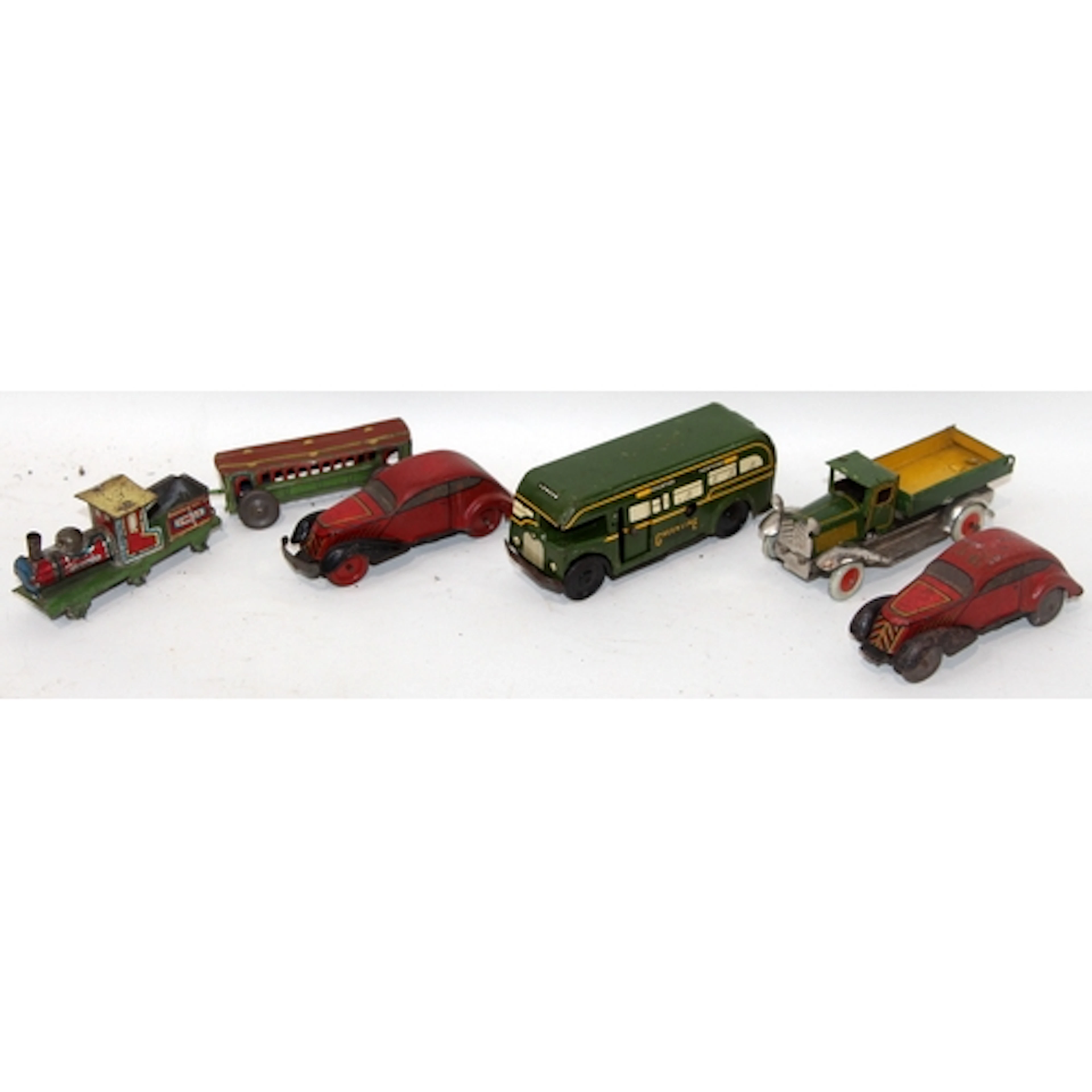A collection of vintage tinplate toy vehicles including cloc...