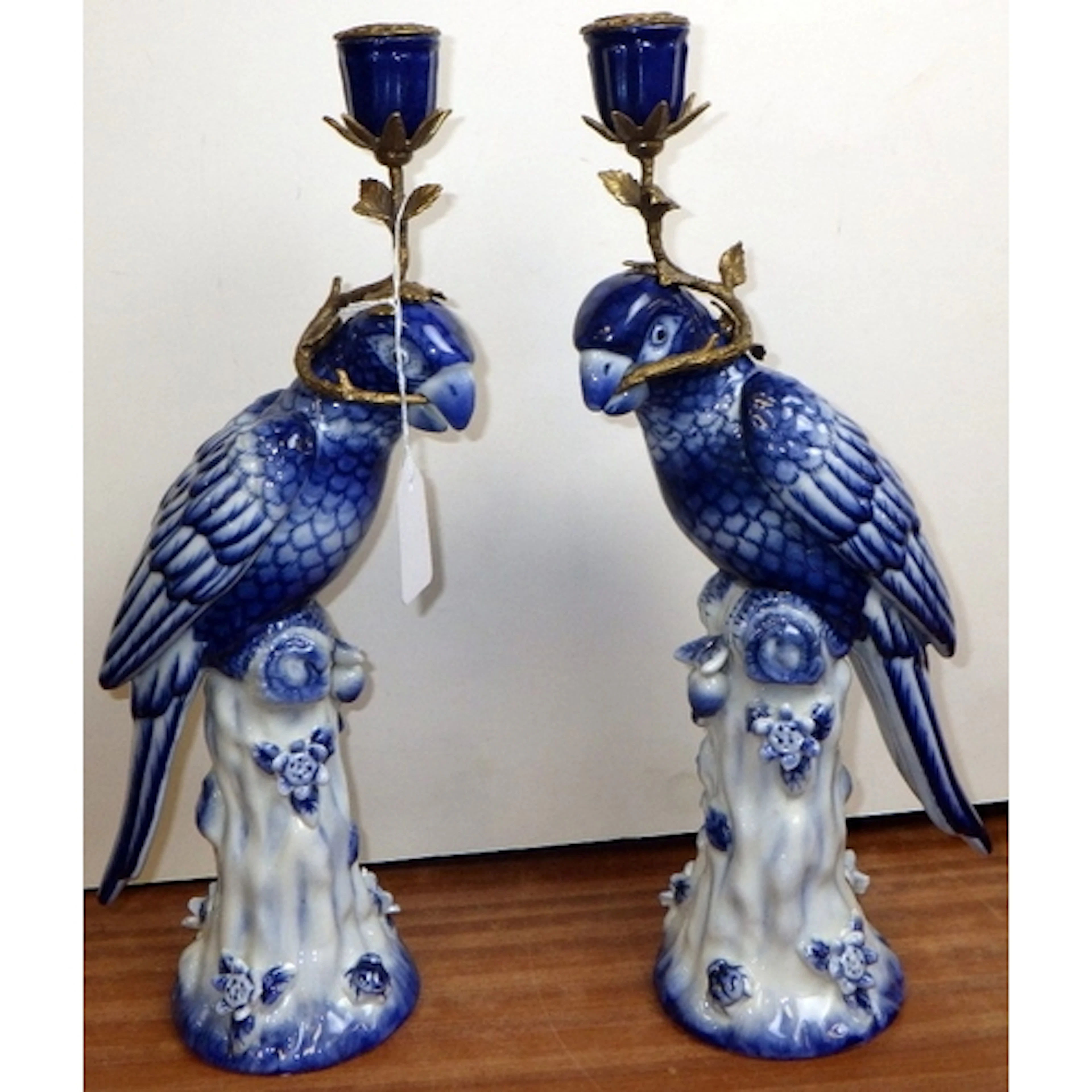 A pair of ceramic blue & white parrot candlesticks