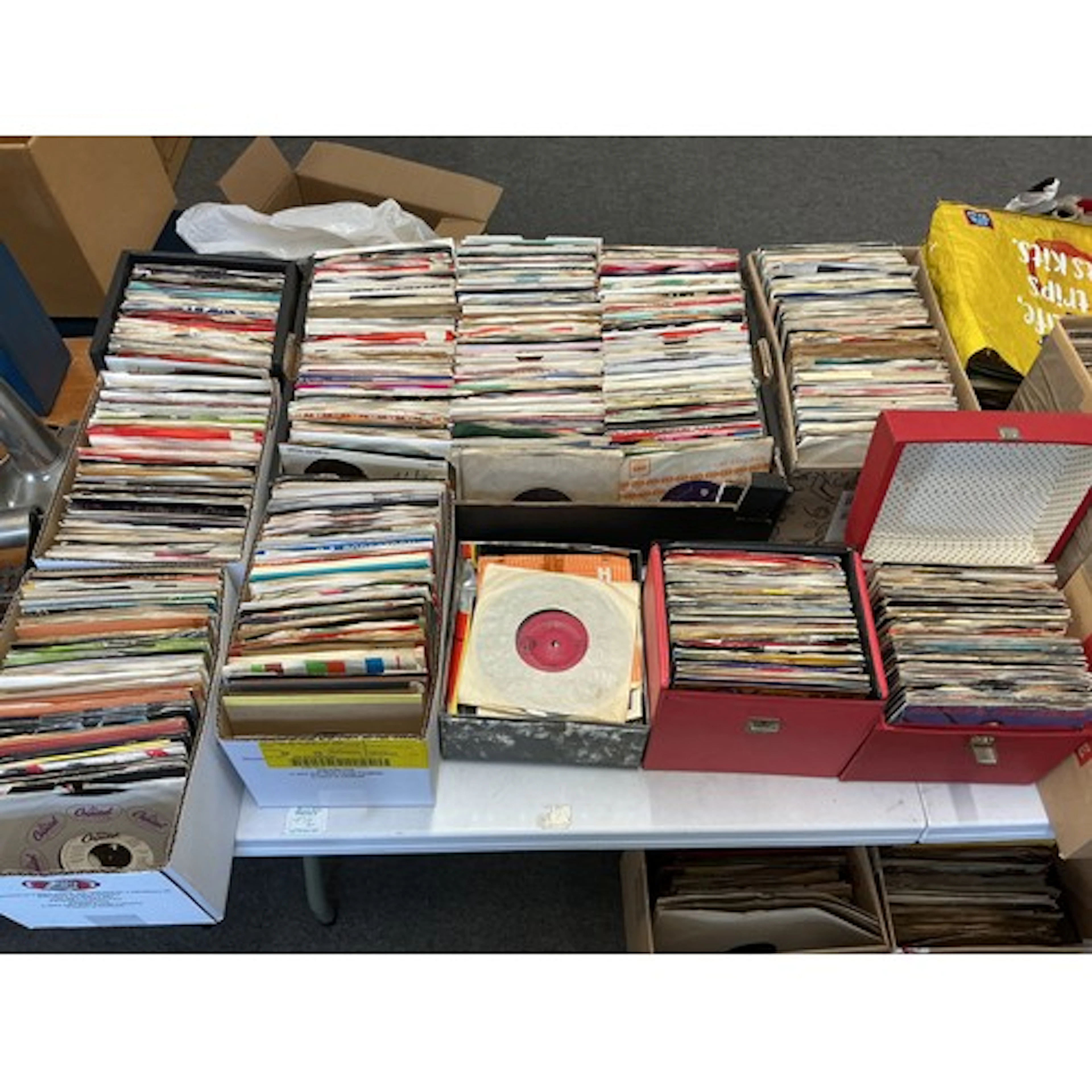 Three record cases and six small boxes of 7” singles by vari...
