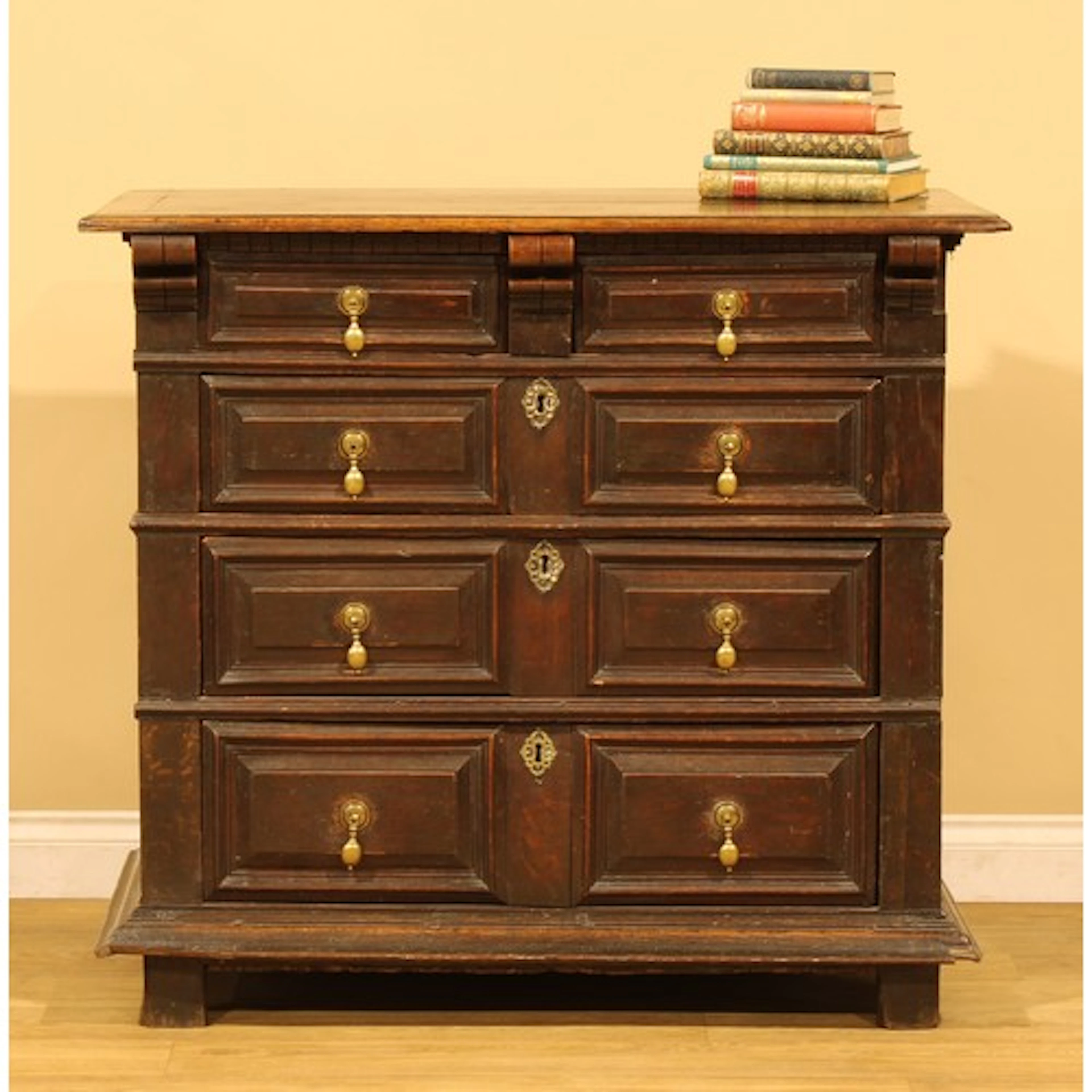 A Charles II oak block front chest, oversailing top above an...