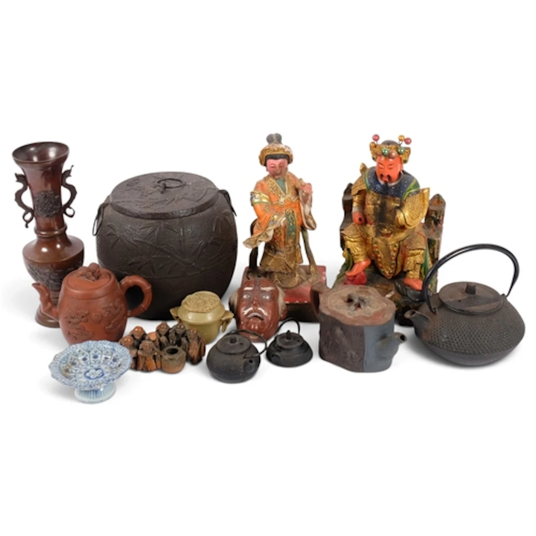 A group of Asian artefacts, including a large cast-iron cadd...