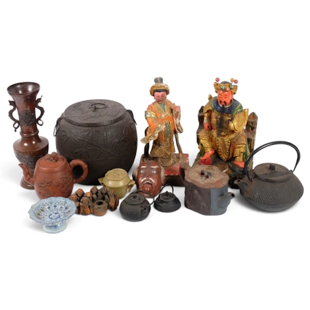A group of Asian artefacts, including a large cast-iron cadd...