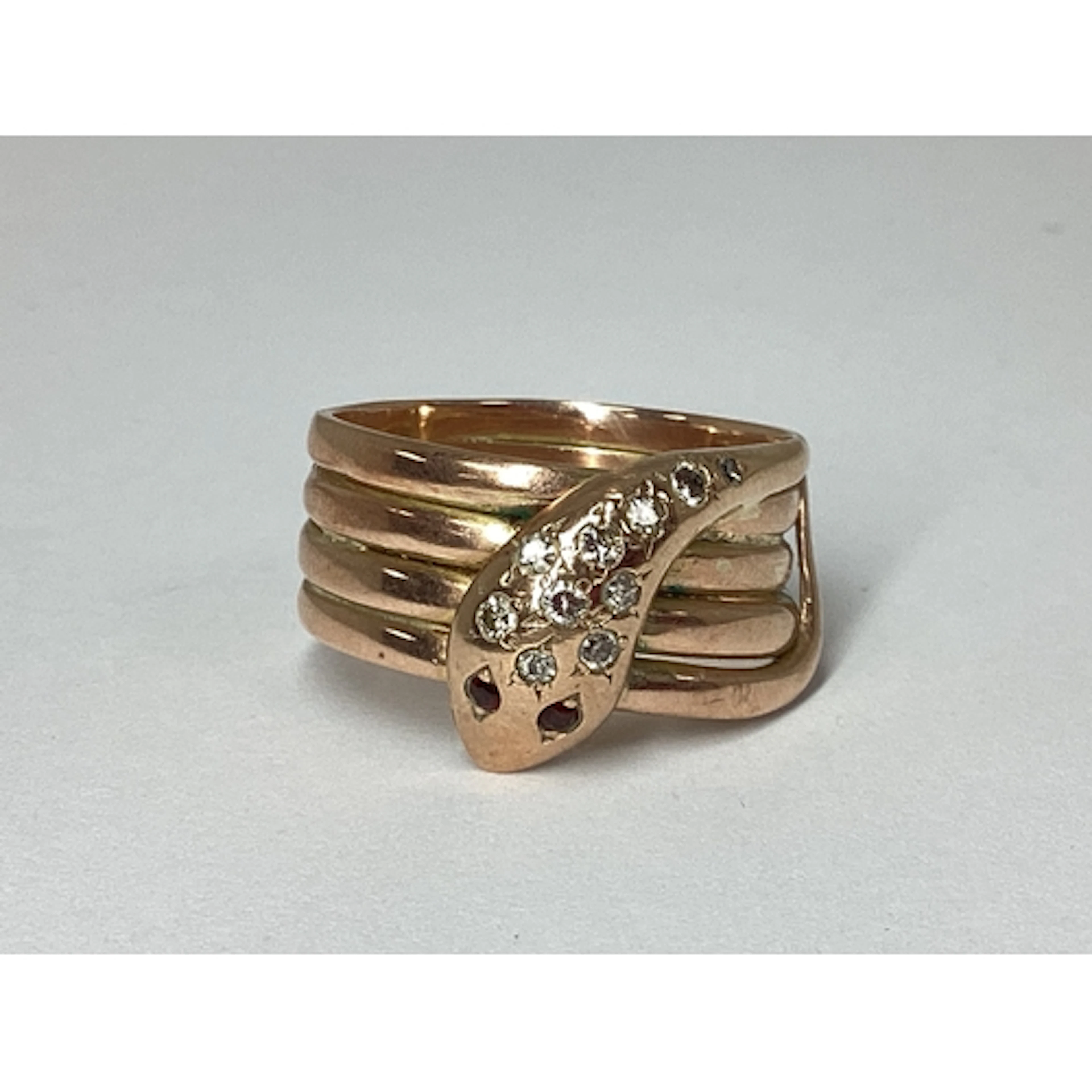 An Antique 9ct Rose Gold Diamond Inset Serpent Ring, the wid...
