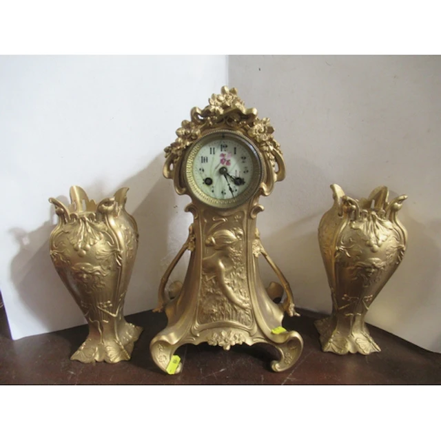 An Art Nouveau clock garniture, the clock with floral decora...