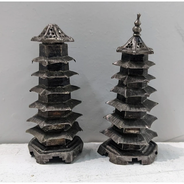 A pair of Chinese white metal condiments, each of pagoda for...