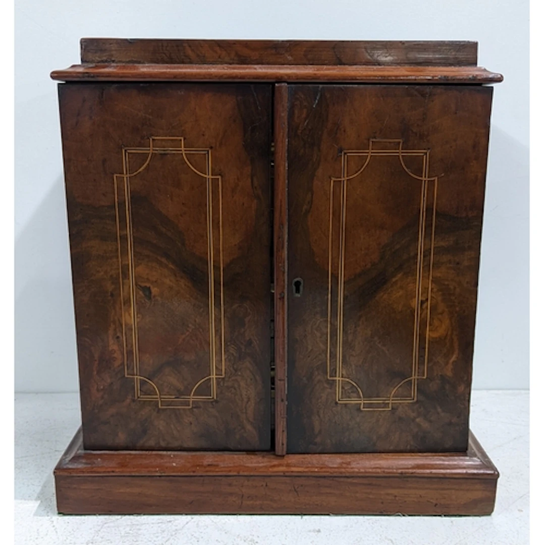 A 19th century walnut desk top collectors cabinet having two...