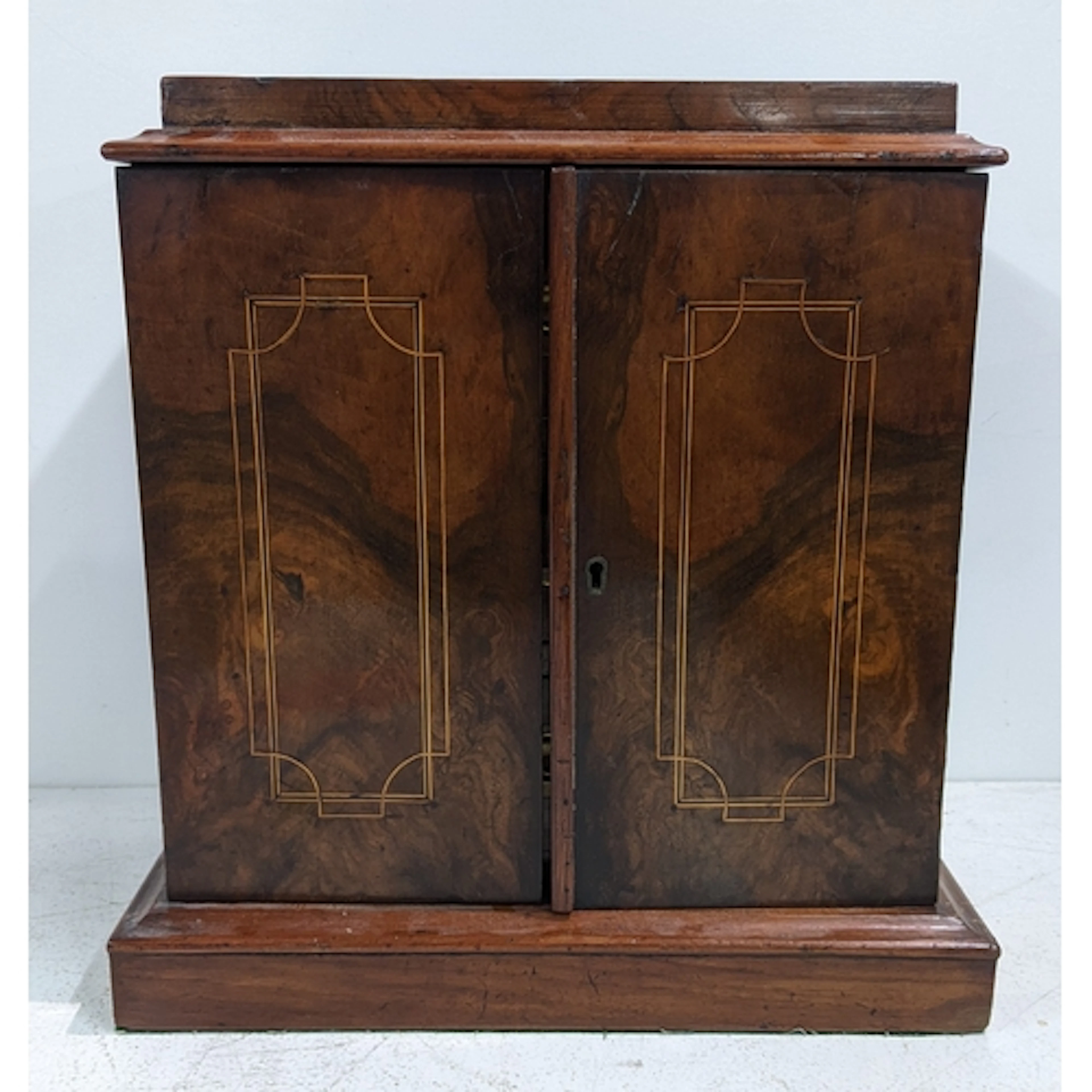 A 19th century walnut desk top collectors cabinet having two...
