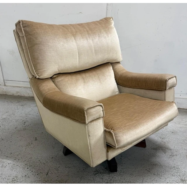 A mid-century swivel arm chair by Everest Furniture in a cre...