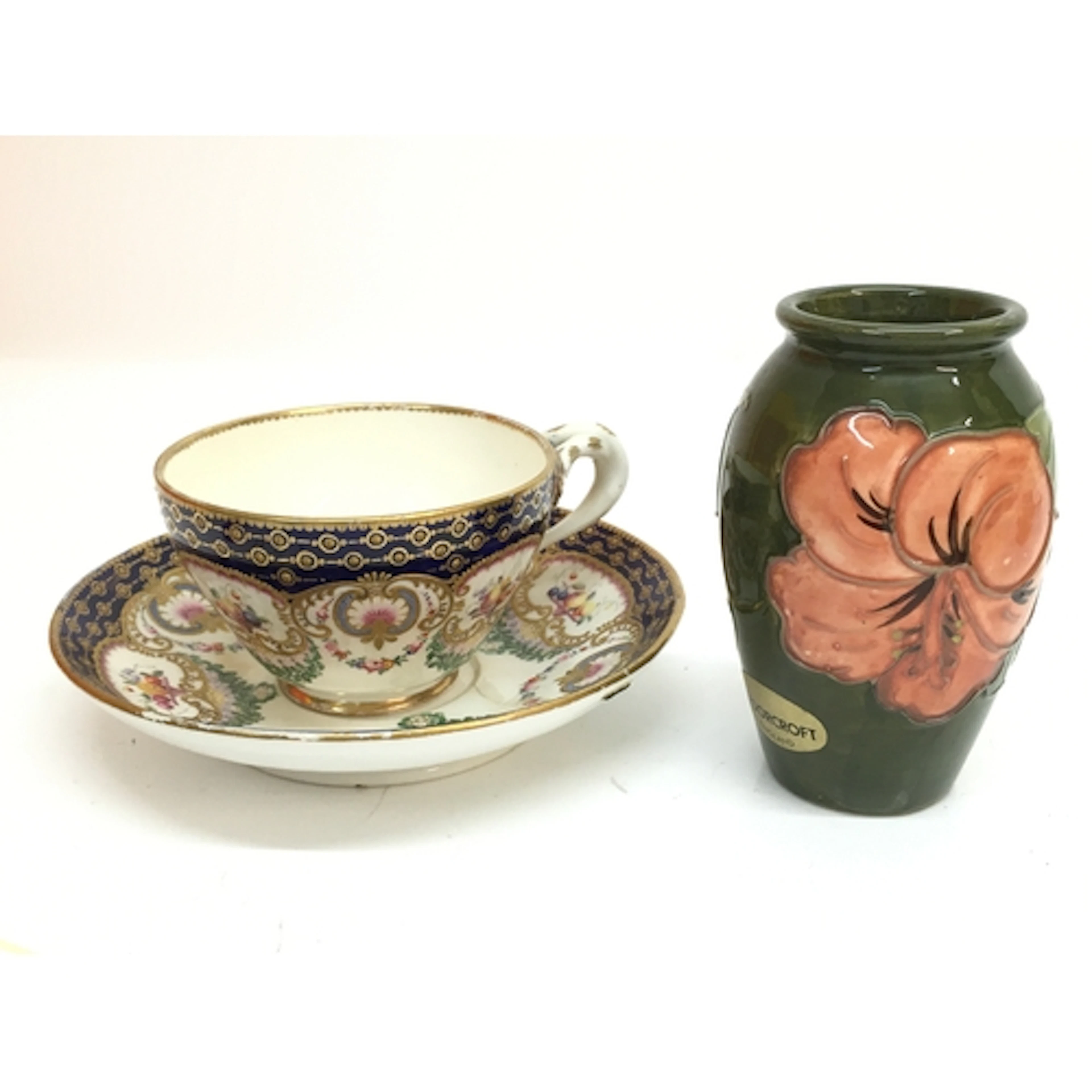 A 19th century cup and saucer and a Moorcroft vase