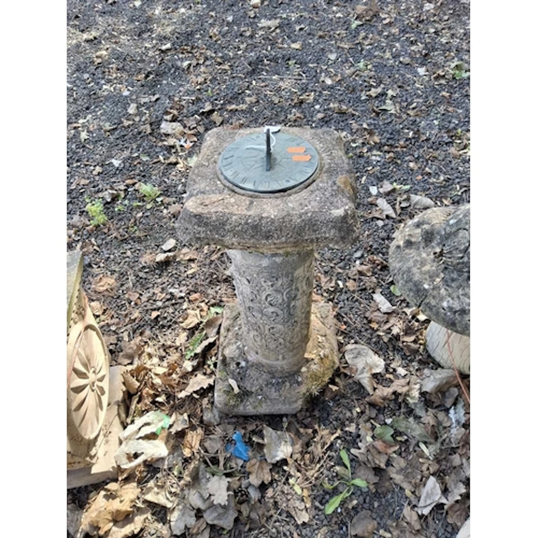 A BRASS AND CONCRETE SUNDIAL with foliate detail to column b...