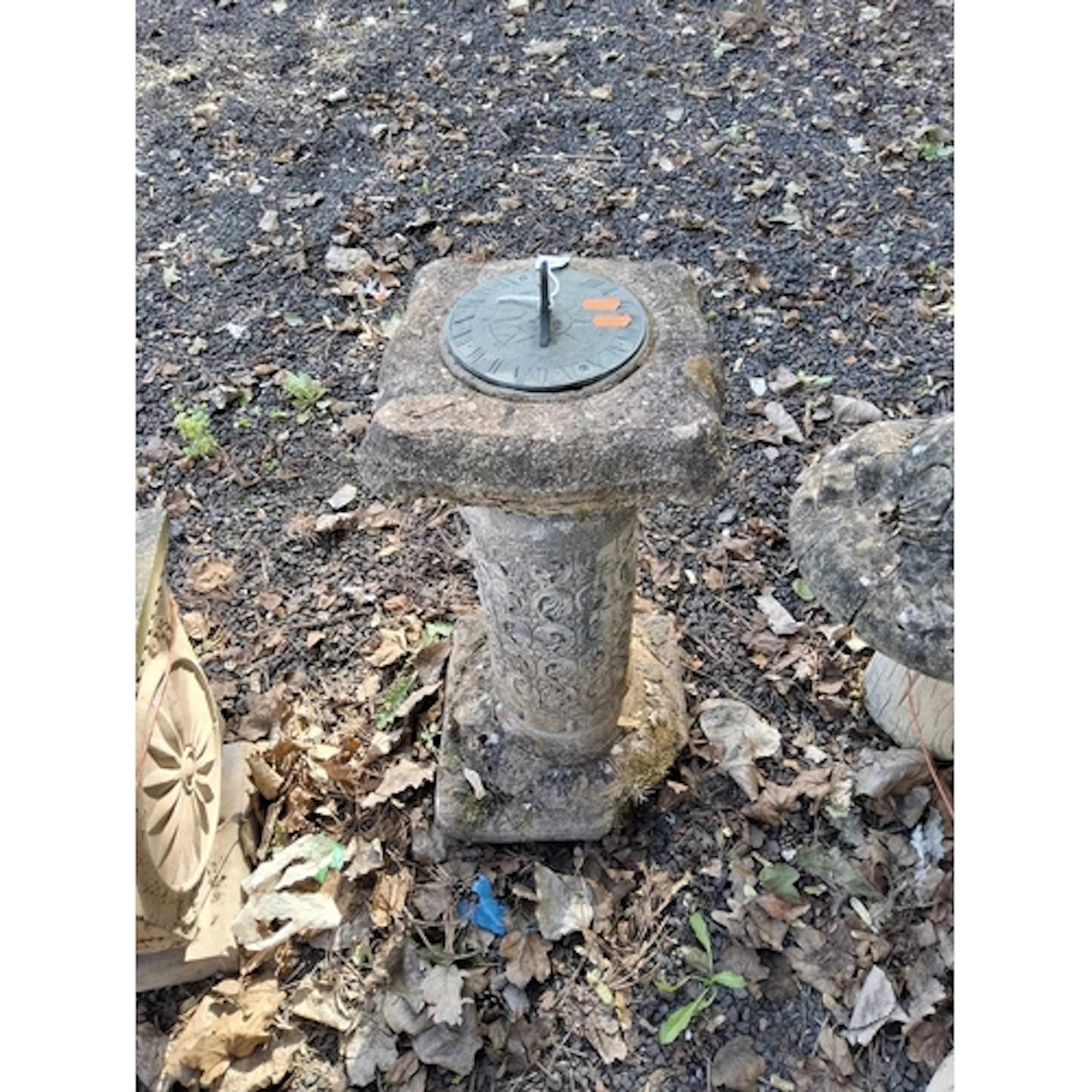 A BRASS AND CONCRETE SUNDIAL with foliate detail to column b...