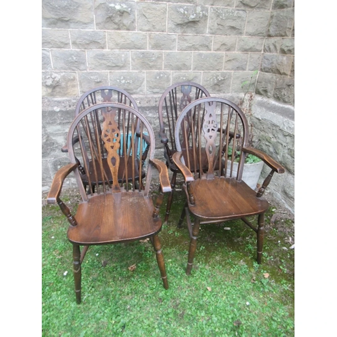 A set of four wheelback arm chairs