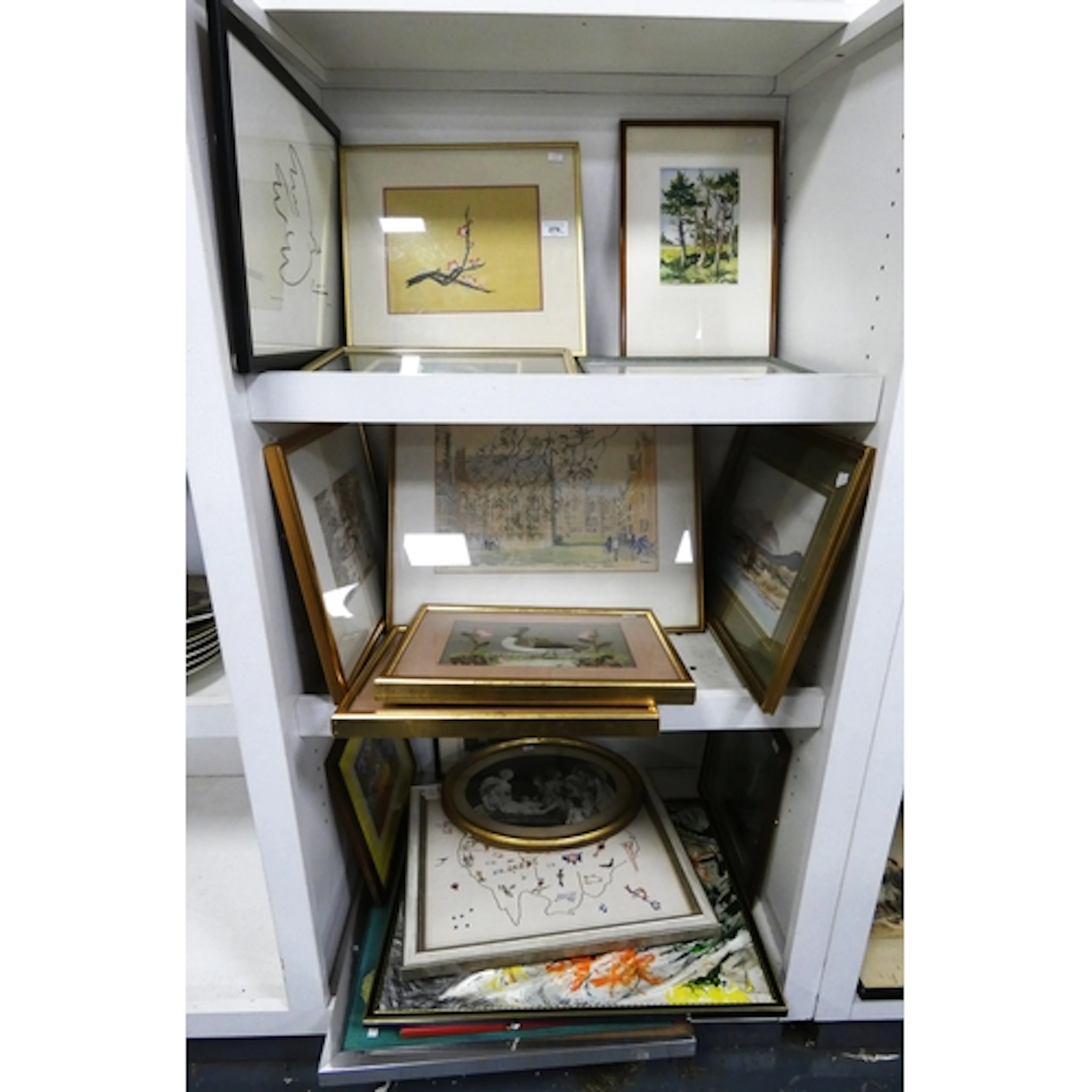 Three shelves of assorted amateur artist pictures and prints...