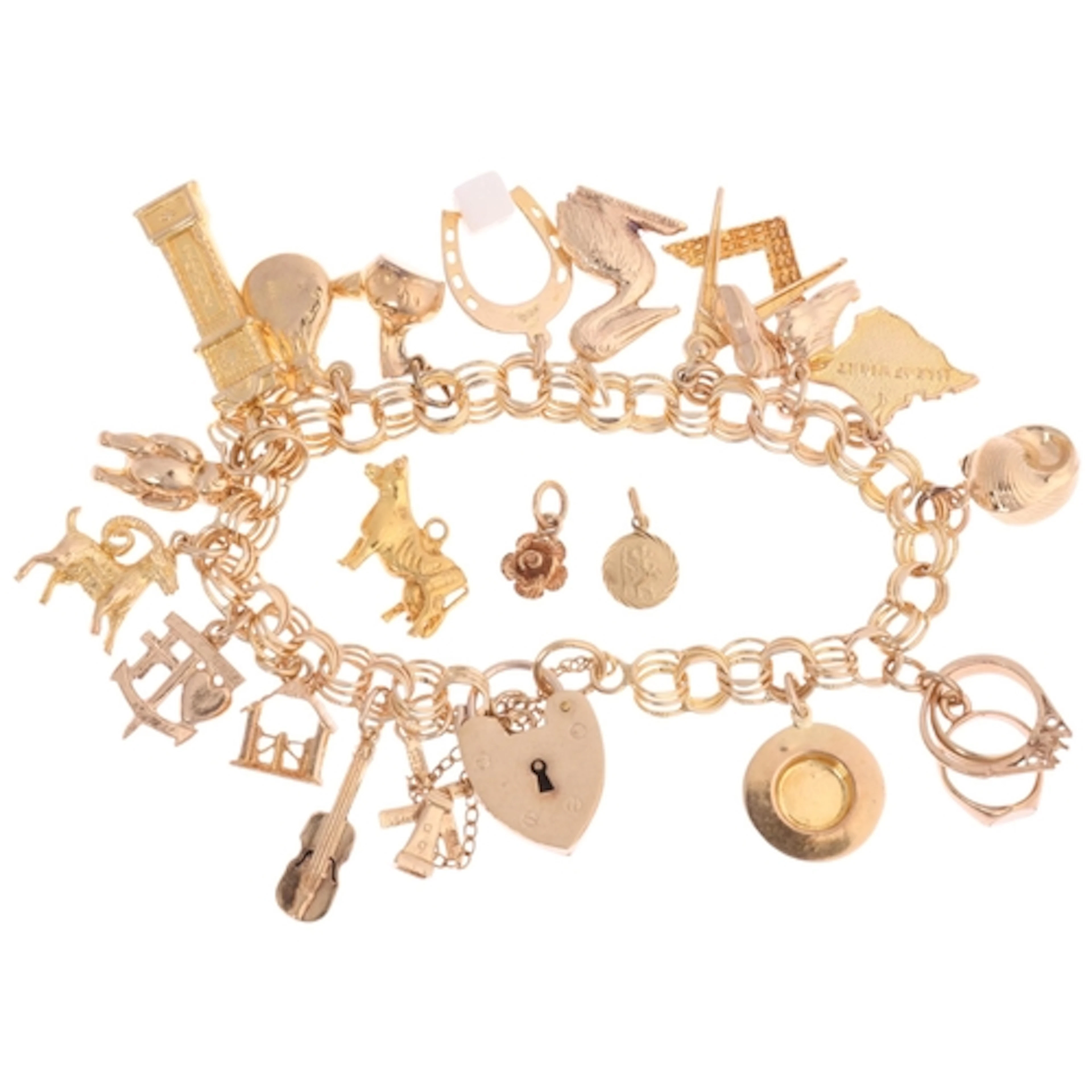 A Vintage 9ct gold charm bracelet, with various novelty 9ct ...