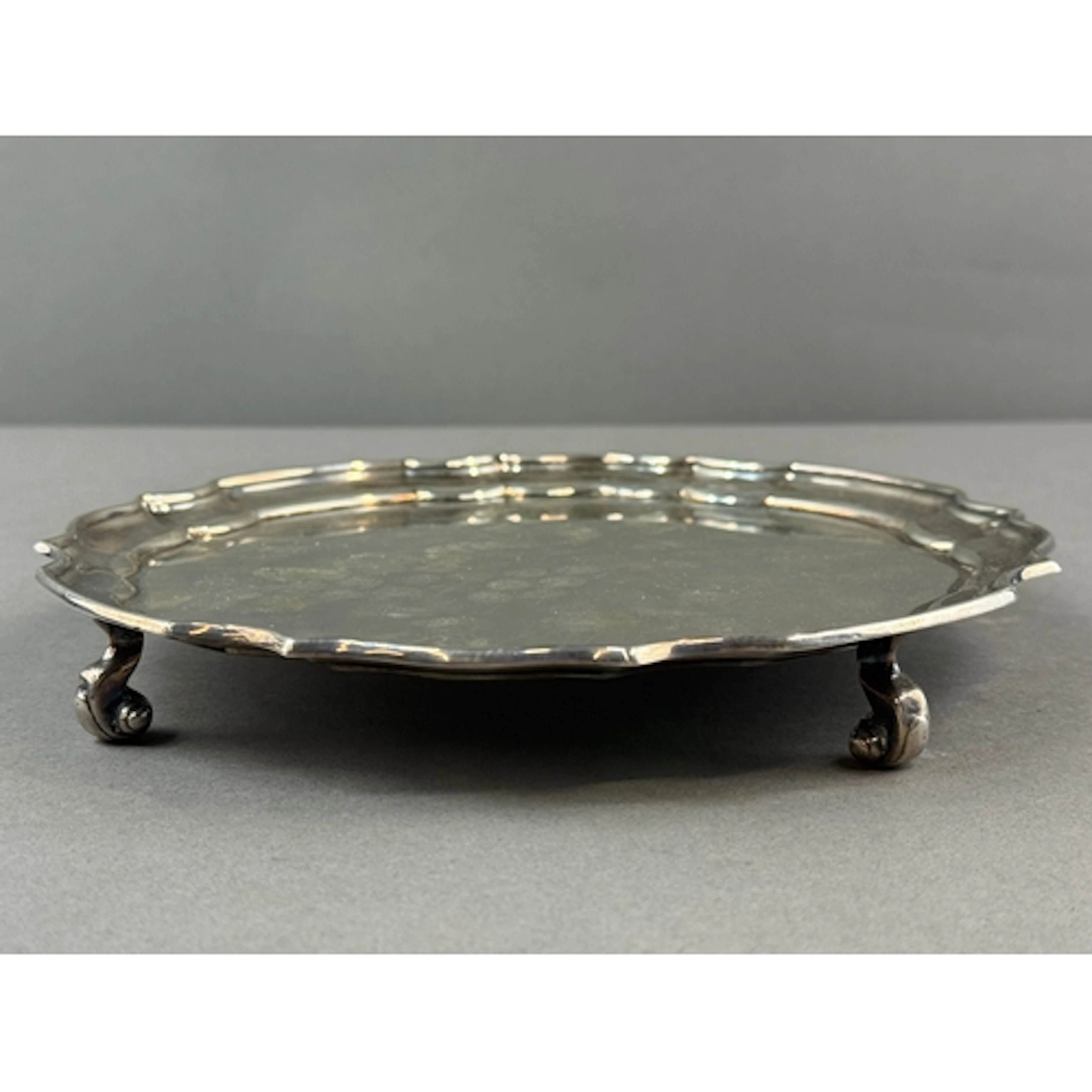 Silver: a plain silver salver with piecrust rim and standing...
