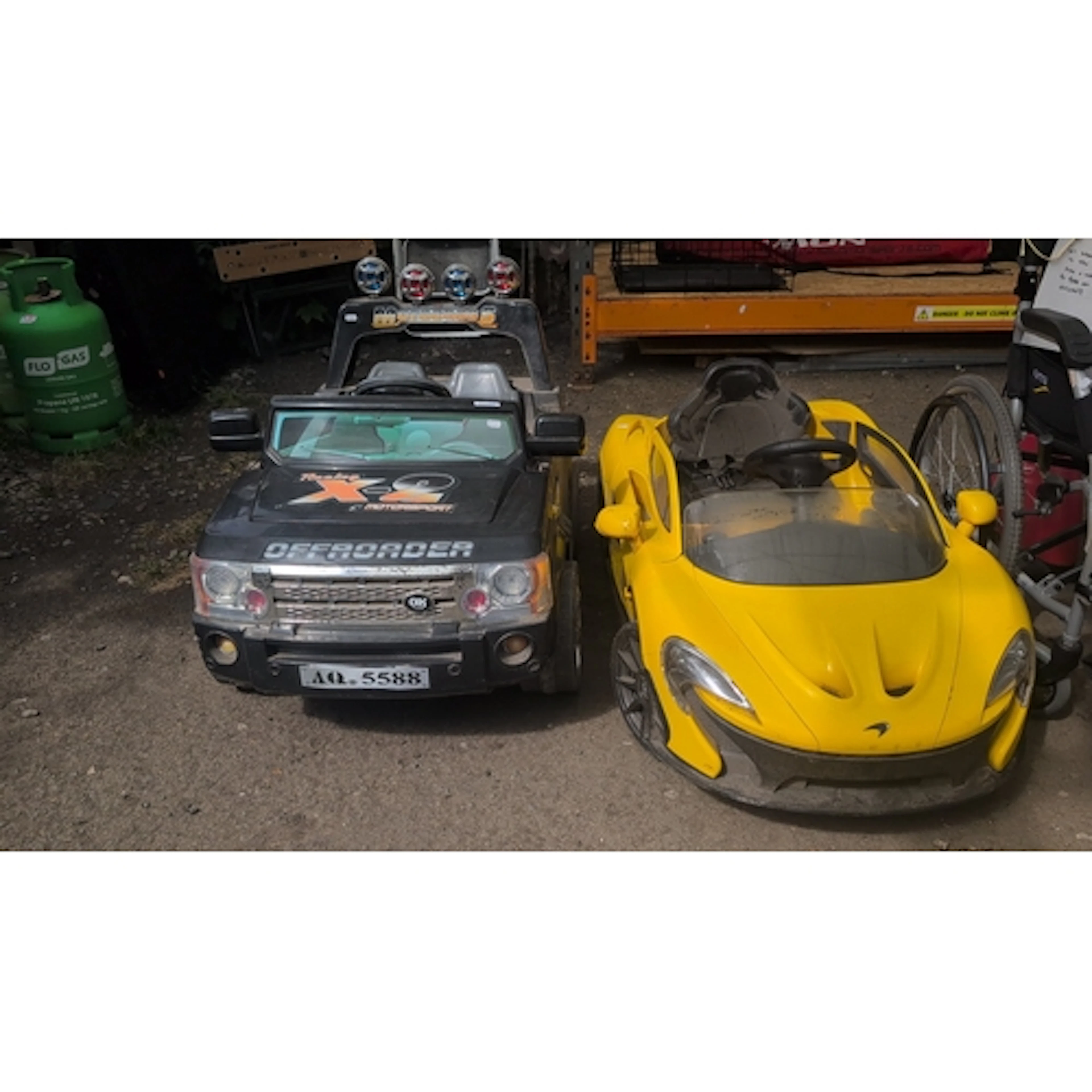 A pair of children’s ride-on battery-powered vehicles: a bla...
