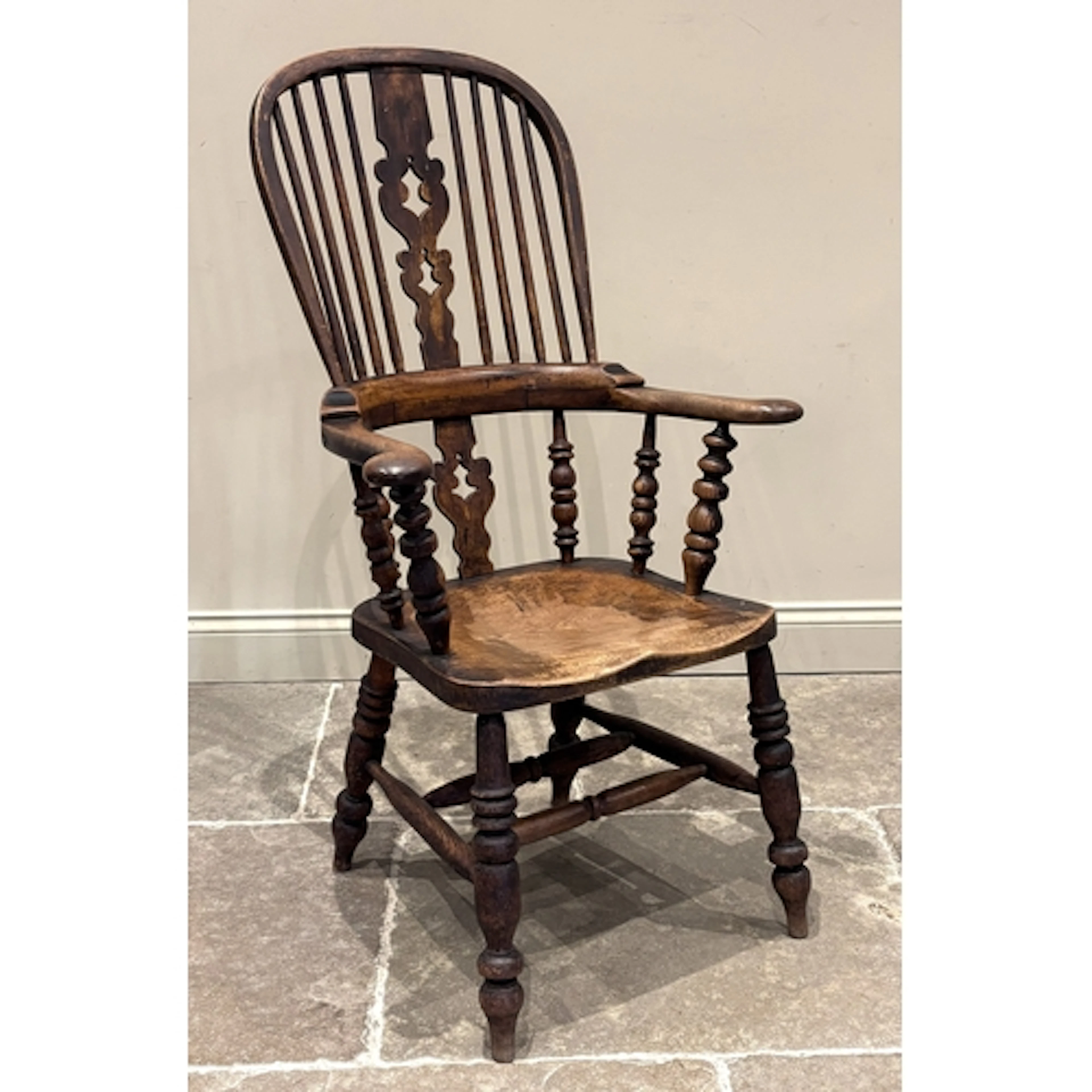 An ash and elm Windsor farmhouse kitchen armchair, the spind...
