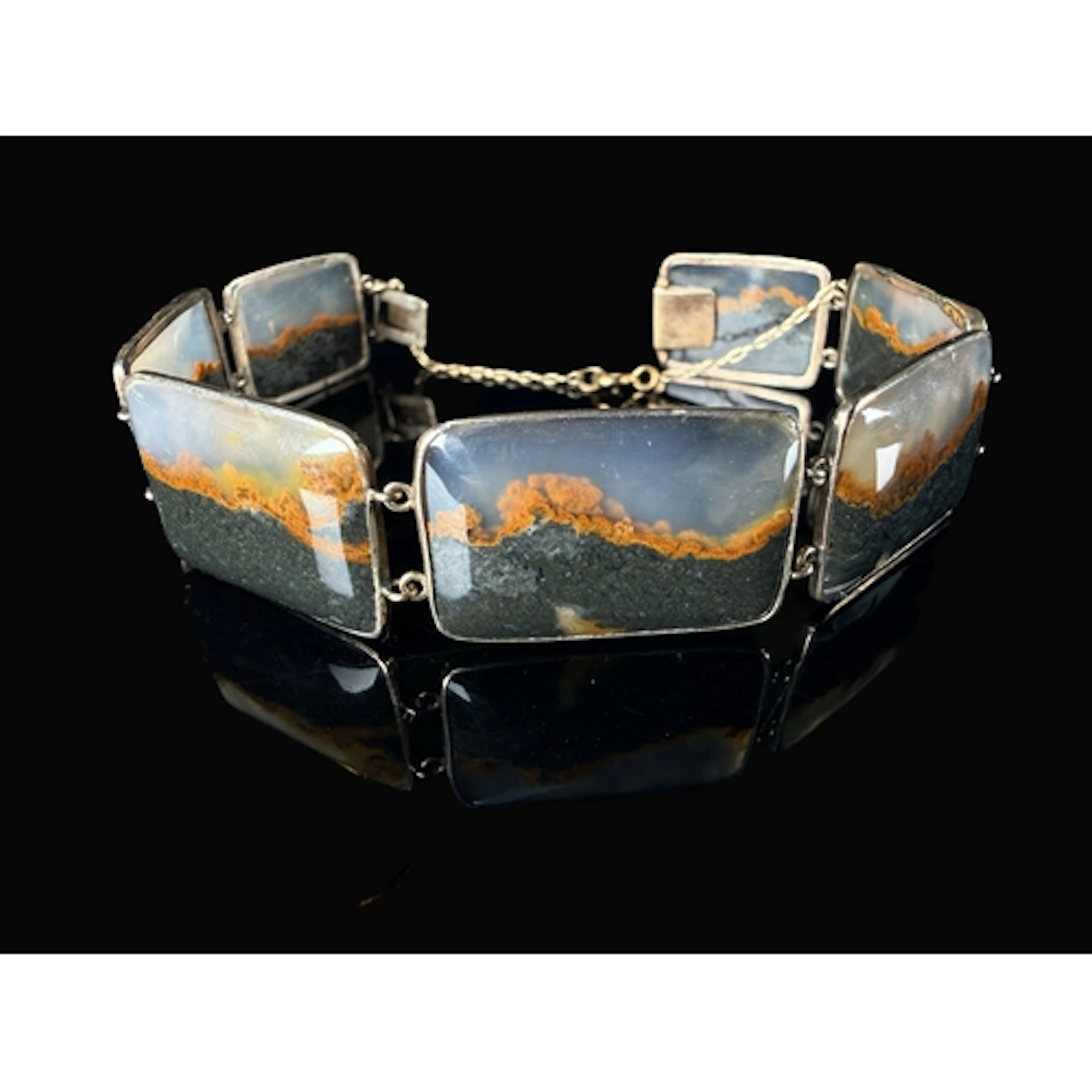 A bracelet formed from rectangular polished banded agate sto...