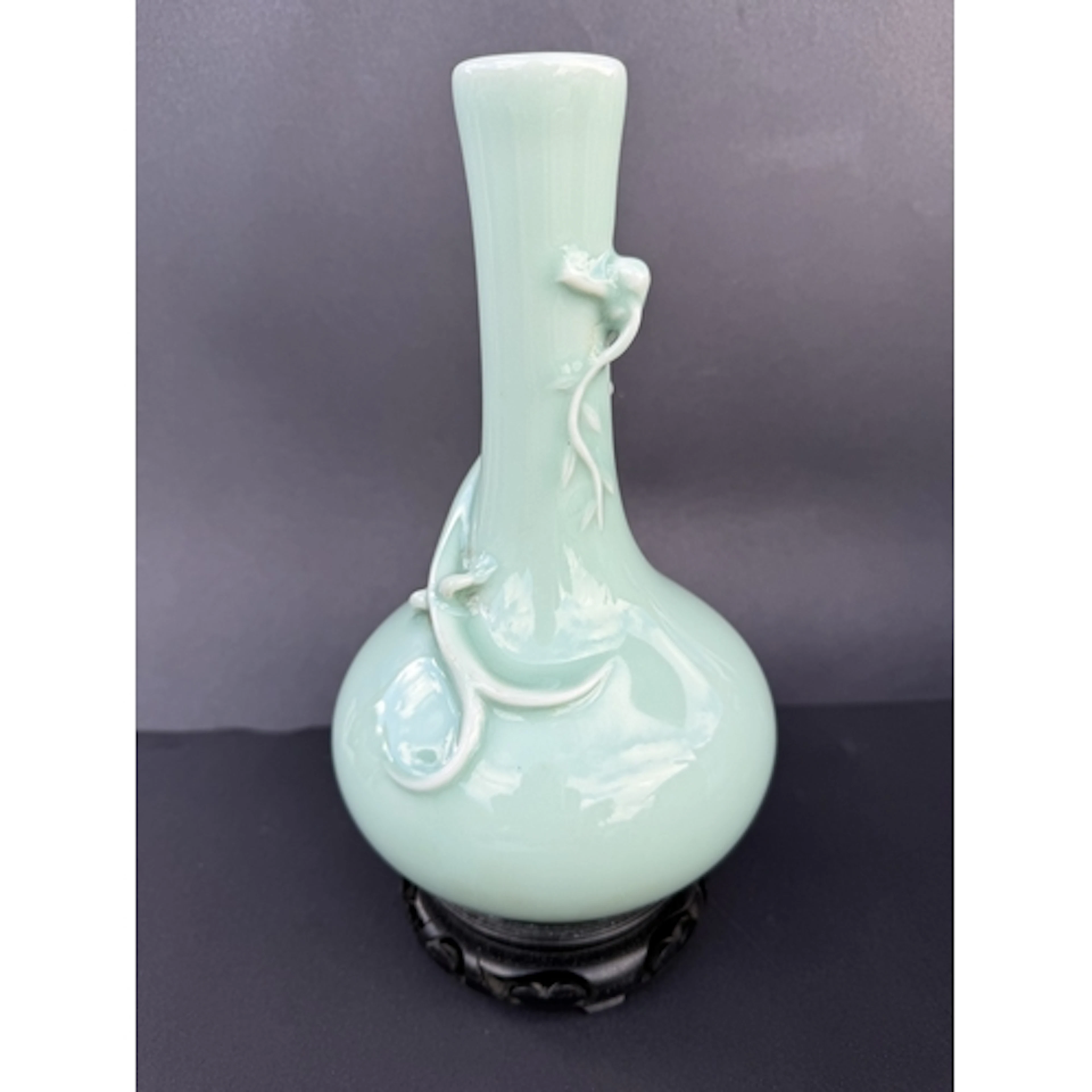 A pale green celadon porcelain bottle vase with applied drag...