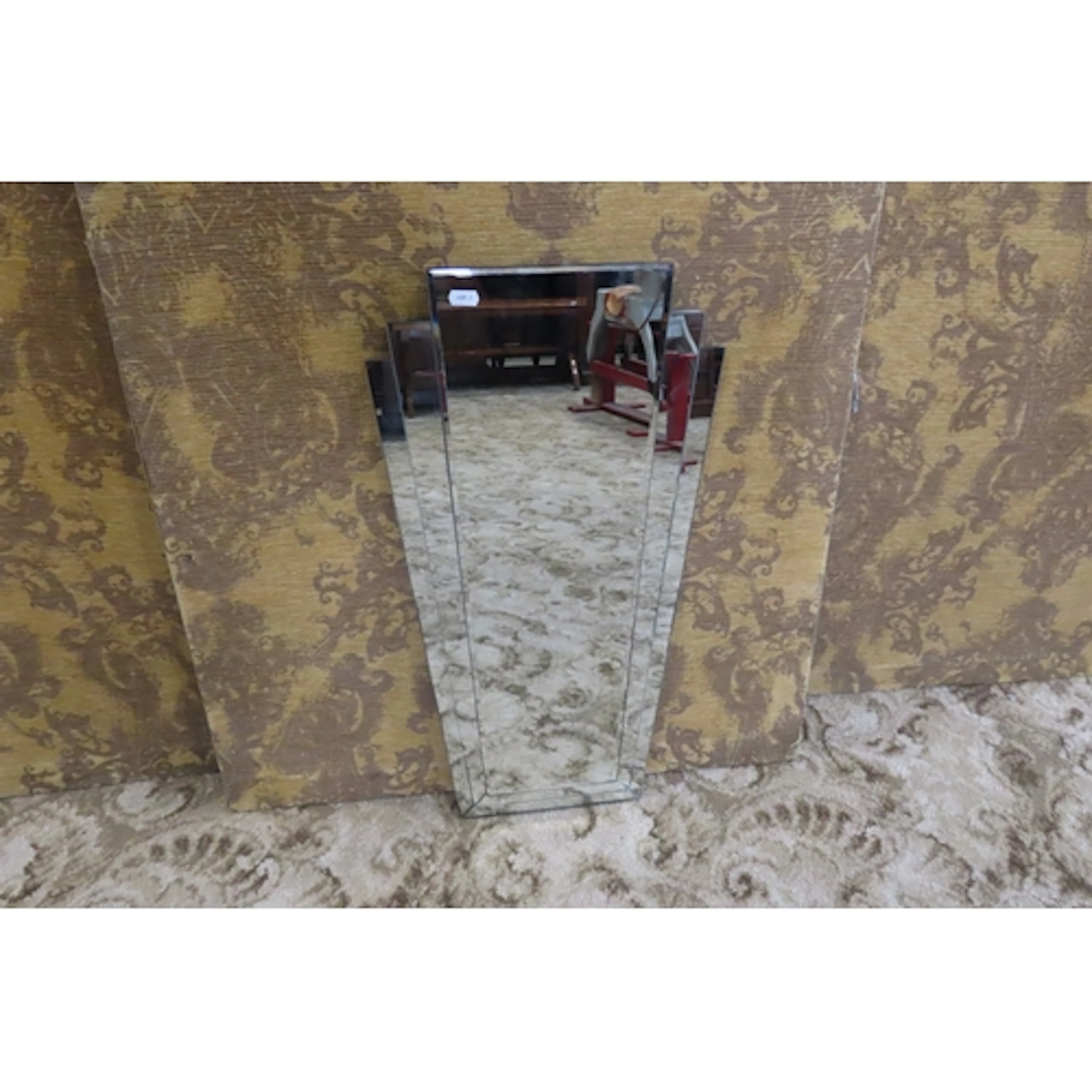A contemporary art deco style wall mirror of tapered stepped...