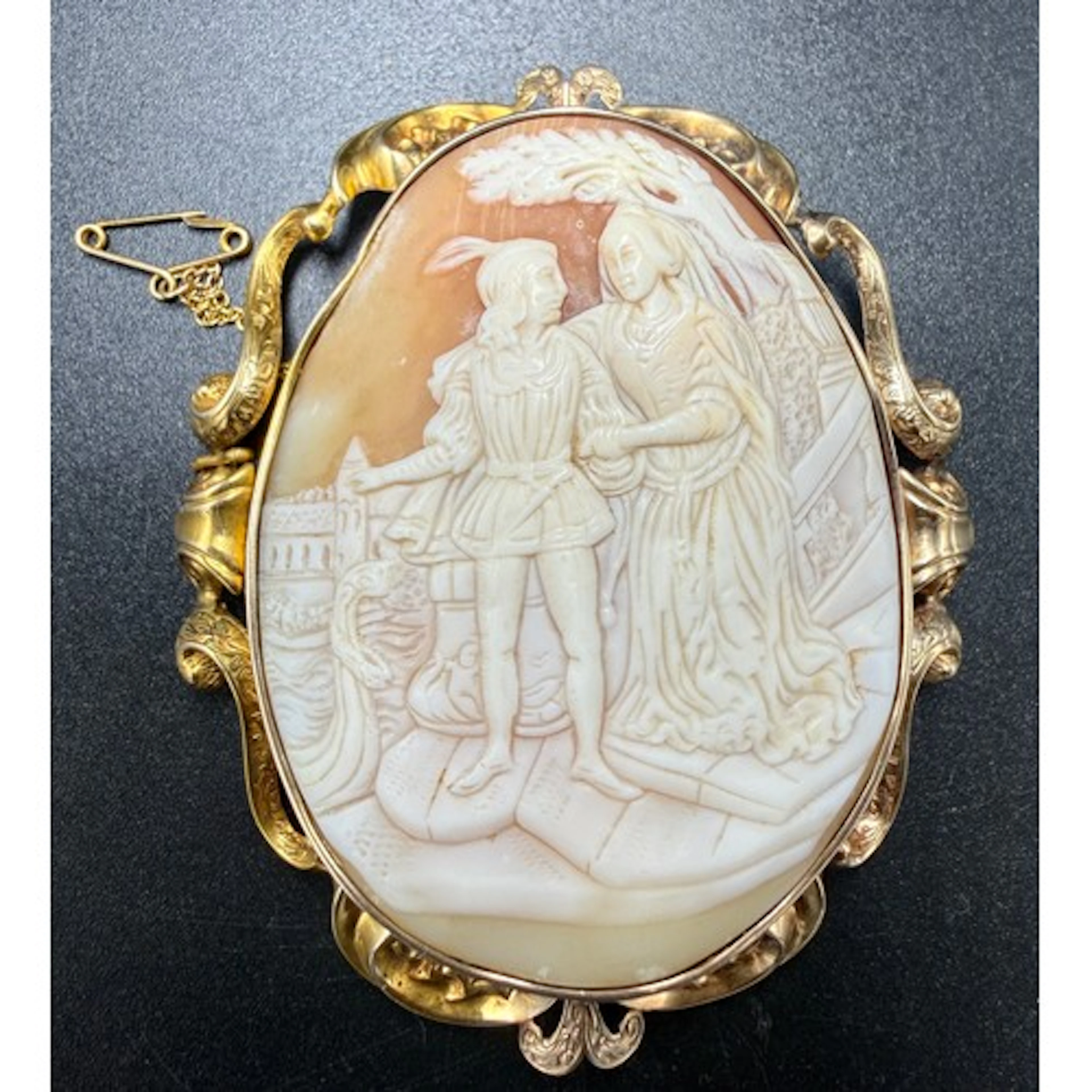 A 19thC carved shell cameo brooch set in a decorative yellow...