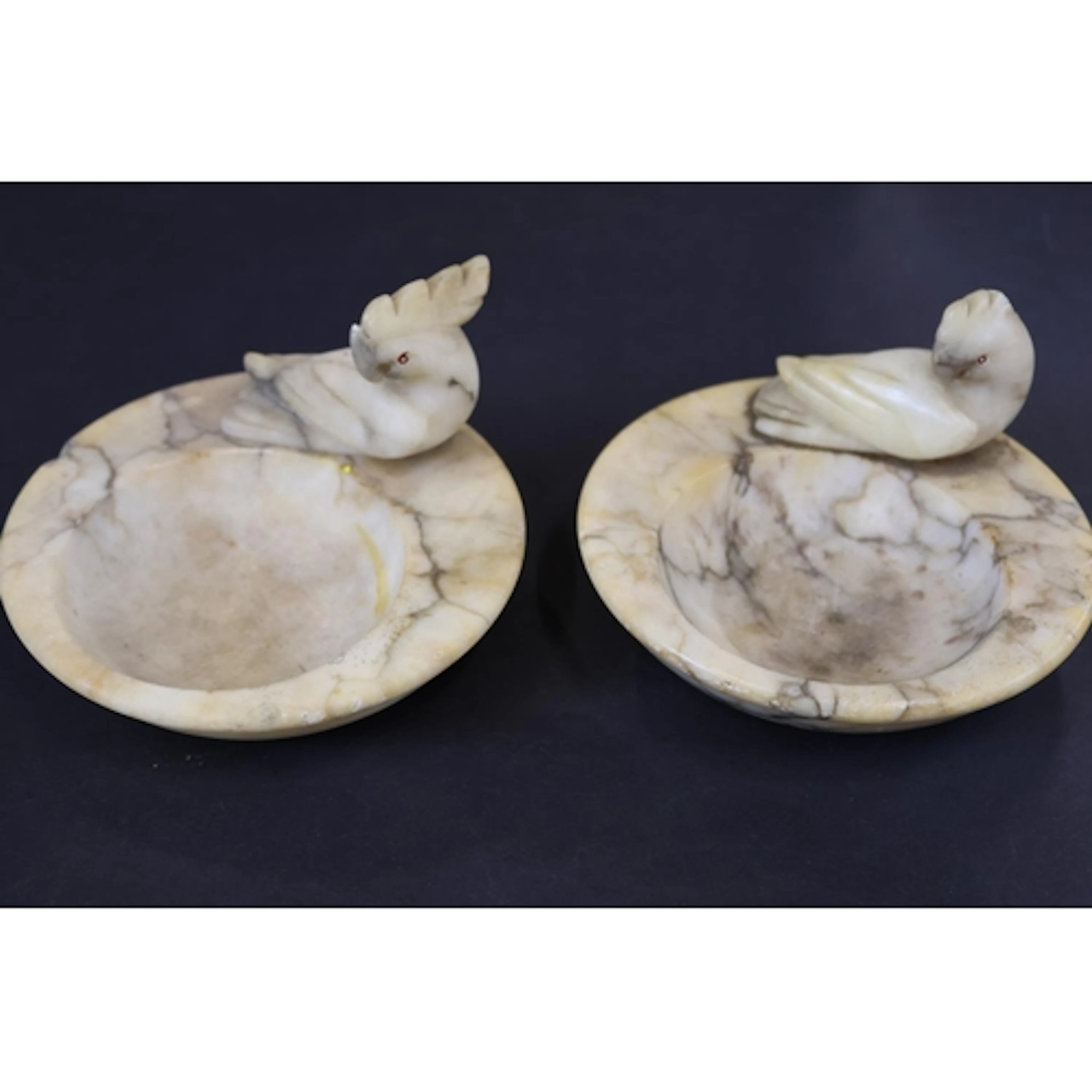 Two alabaster trinket dishes with bird surmounts.