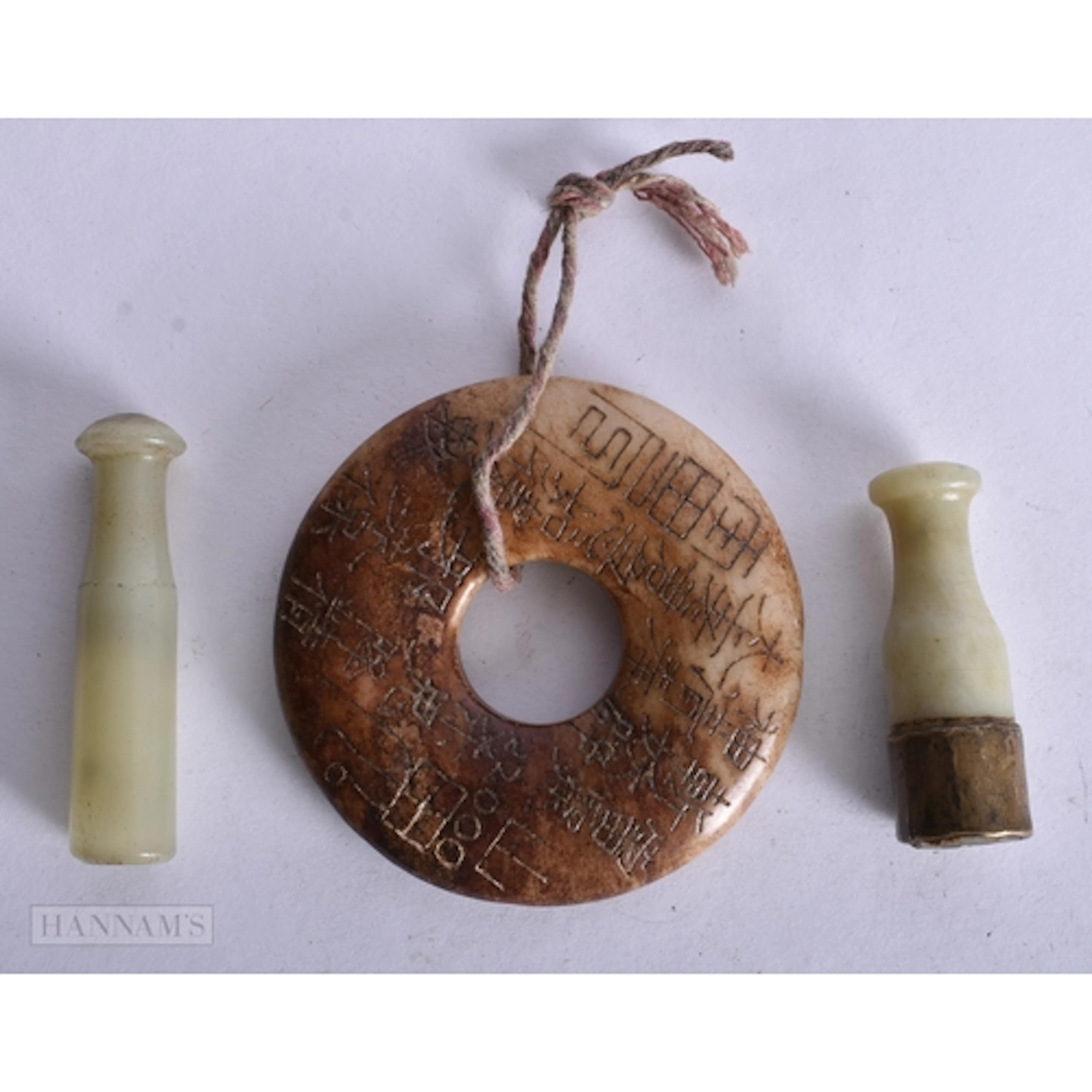 A CHINESE QING DYNASTY JADE ROUNDEL together with two jade p...