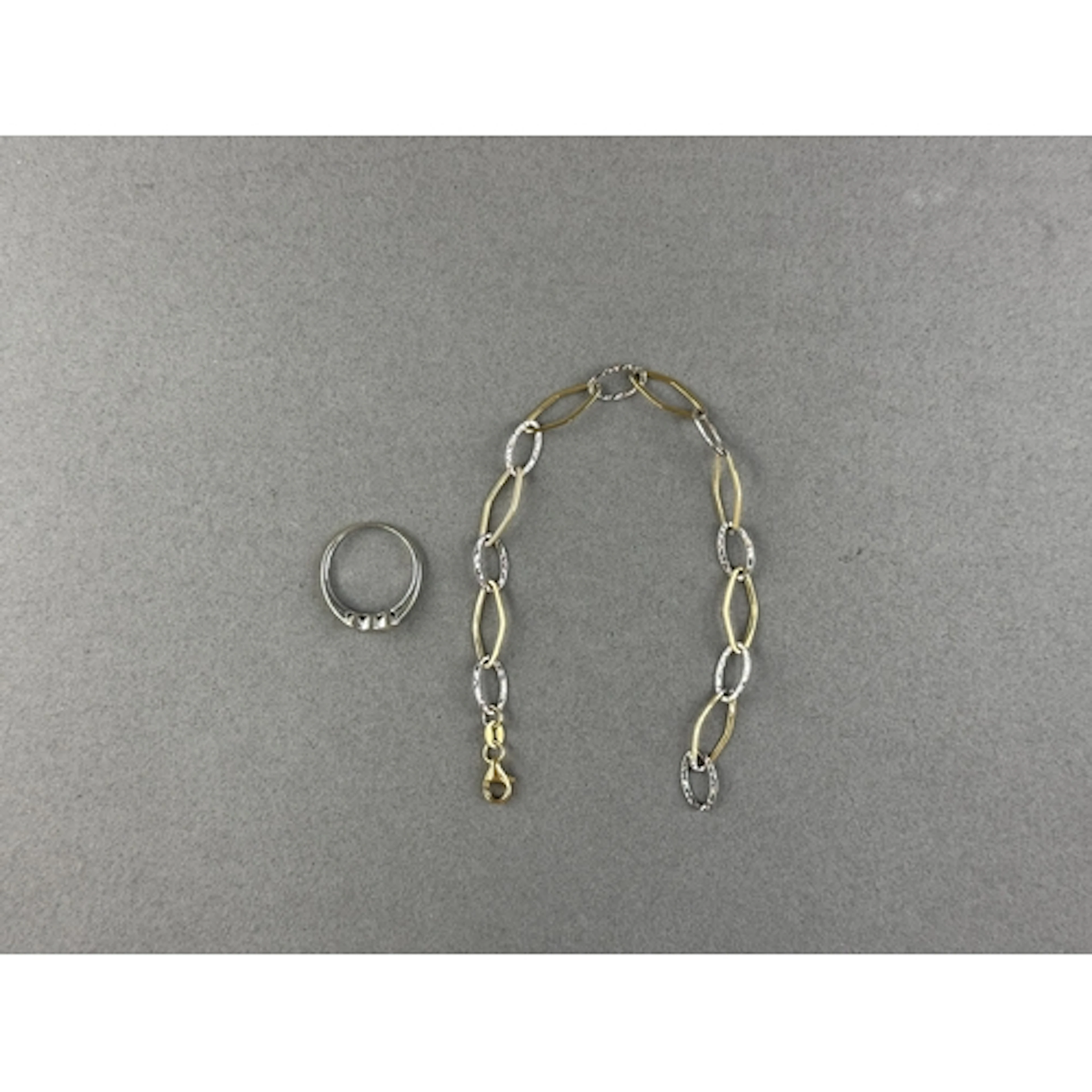 Jewellery: White metal ring, rub over set with three brillia...