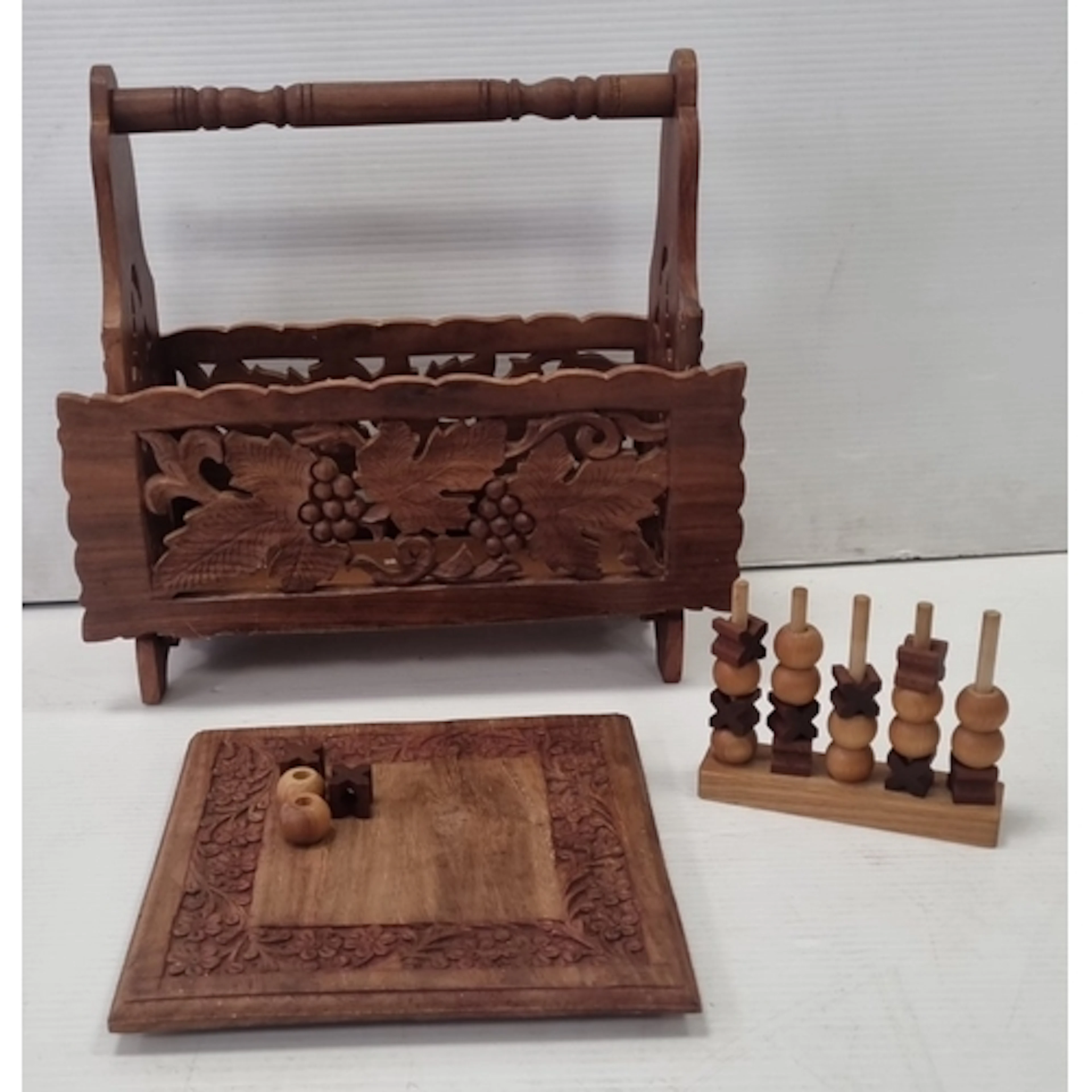 Carved wooden magazine rack and game board with playing piec...